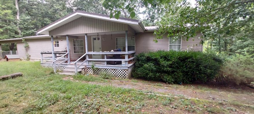 Country Living with Endless Possibilities! Looking for space, privacy, and potential? This 3 bedroom, 2 bath double wide sits on 8.59 peaceful acres in the heart of the country and offers more than just room to roam! Featuring new flooring throughout, a mudroom addition, and front and and back porch for enjoying the serene surroundings. The property includes a covered carport, 8 outbuildings—6 with power—providing ample space for storage, hobbies, or a workshop. One outbuilding even has the potential to be transformed into a cozy guest house with a loft! Enjoy your very own stocked pond, ideal for quiet afternoons of fishing or relaxing by the water. With some land clearing, clean up and TLC, it’s the perfect opportunity to own a piece of the country with so much room to make it your own.  Bring your vision and make this rural retreat your reality!