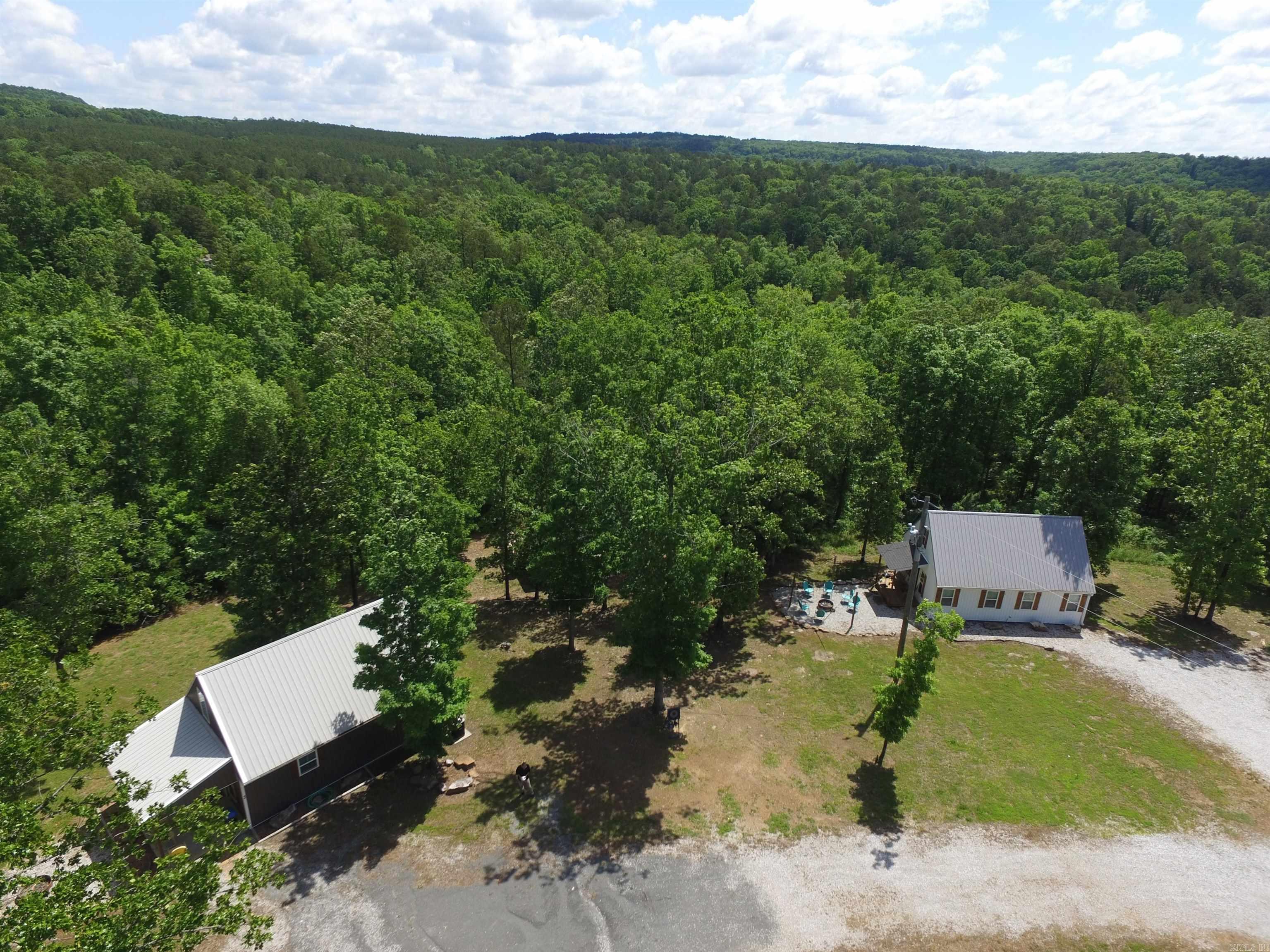 TURNKEY AIRBNB WITH PROVEN CASH FLOW! Glamping in the Ozarks has become popular and these cabins are some of the best in the area. Each heated and cooled cabin has a large bedroom and a sleeping loft as well as an electrical hook-up for an RV for overflow guests. One cabin has two bedrooms plus the loft. For your enjoyment, there is a beautiful wood fired sauna with an outdoor shower located between the cabins,. Enjoy evenings around the campfires making s'mores and memories, telling stories and counting stars. In the morning take a short walk to the bluffs at Midway bridge and jump in the lake to start your day. Or start your day in the sauna followed by an outdoor shower.Then take the short drive to one of 3 nearby marinas for a day on the lake. This unique opportunity can be yours to enjoy! There is an additional RV parking pad to increase your income stream. Come see it all soon.