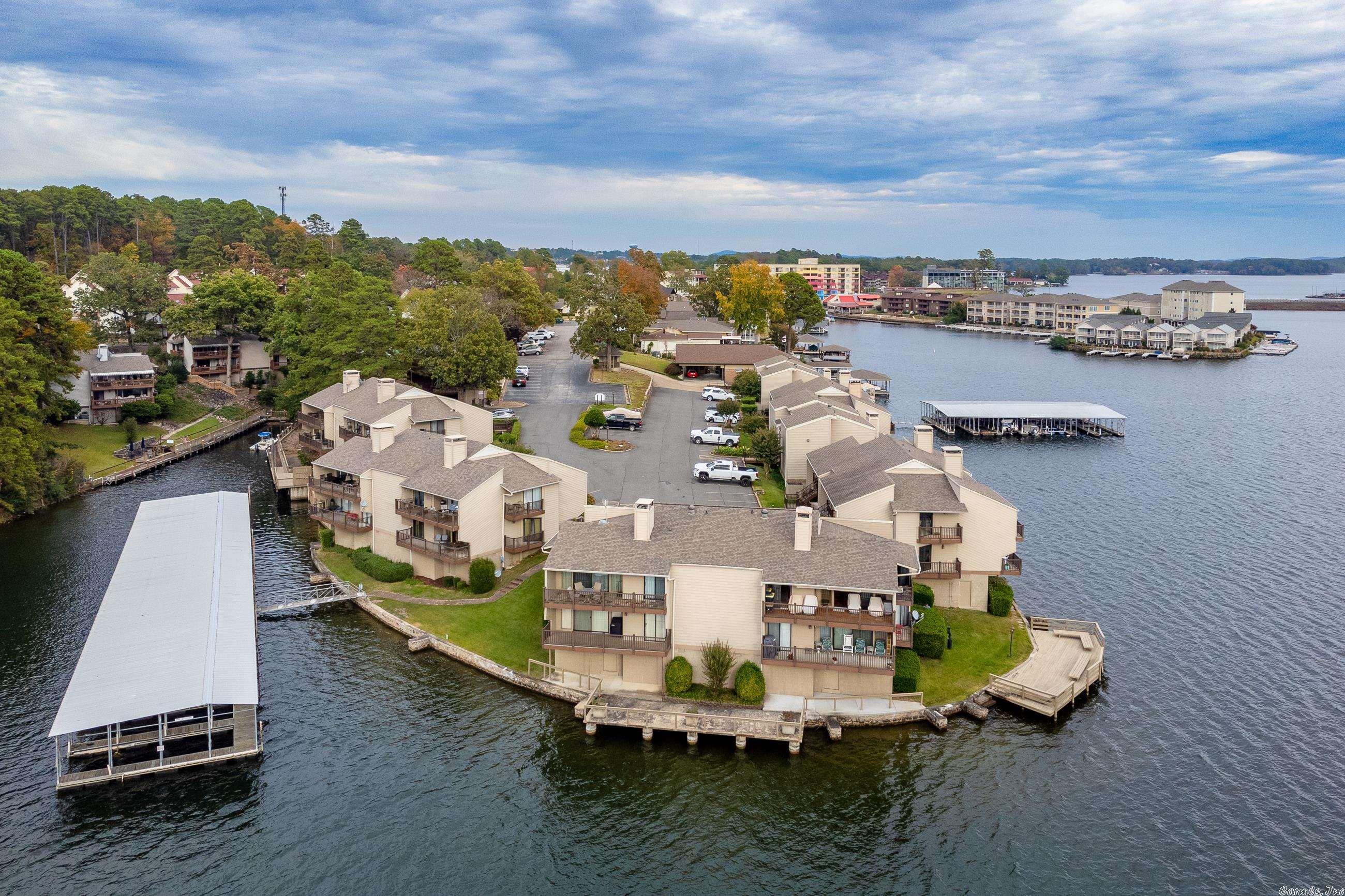 Right on the point at the waters edge unit E3 gives you picturesque main channel and sunset views. 2BD/2BA open floor plan with: solid surface stone counter tops, plantation shutters, walk in main bedroom shower, fully furnished, 2 balconies, and covered boat slip with lift set up for a tri-toon party barge. Complex accommodates short term rentals. Must see to appreciate all this unit has to offer.