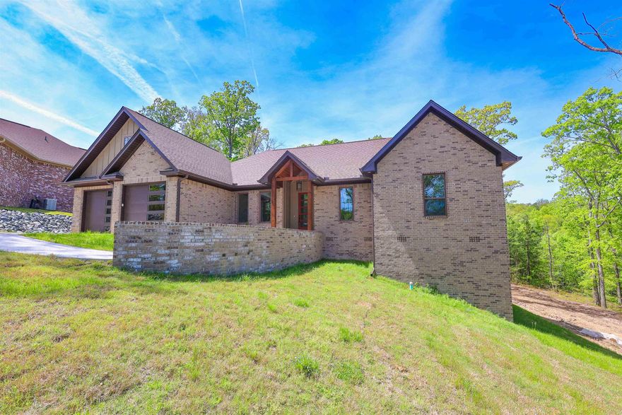 New construction, offering a 4 bedroom, 3.5 bath layout with modern features throughout. Energy-efficient appliances, an efficient heat-and-air system, and a tankless caution hot water heater. Vaulted ceilings and two gas-powered fire inserts create a warm, inviting atmosphere.  A standout feature is the bonus room located behind the home, built with cement walls—ideal for use as a safe room, storm shelter, hobby space, or secure storage.