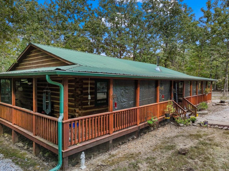 Escape to the Ozarks in this authentic log cabin retreat just over a mile from the Ranchette launch on the White River! Nestled on 5.81 acres, this 2 bedroom, 2 bath log home offers timeless charm with modern comforts. Inside, enjoy the warmth of a gas log fireplace plus a wood stove in the spacious living room, perfect for cozy evenings. A detached garage with a third bathroom provides extra convenience and storage. The wraparound covered porch invites you to relax and take in the peaceful surroundings, while the metal roof ensures long-lasting durability. Designed with low maintenance in mind, the yard features ample gravel for easy trailer turnarounds, RV hookup, and plenty of room for all your outdoor gear. Whether you’re seeking a full-time home, weekend getaway, or river adventure basecamp, this cabin combines rustic character with practical updates, all in an unbeatable location close to world-class fishing.