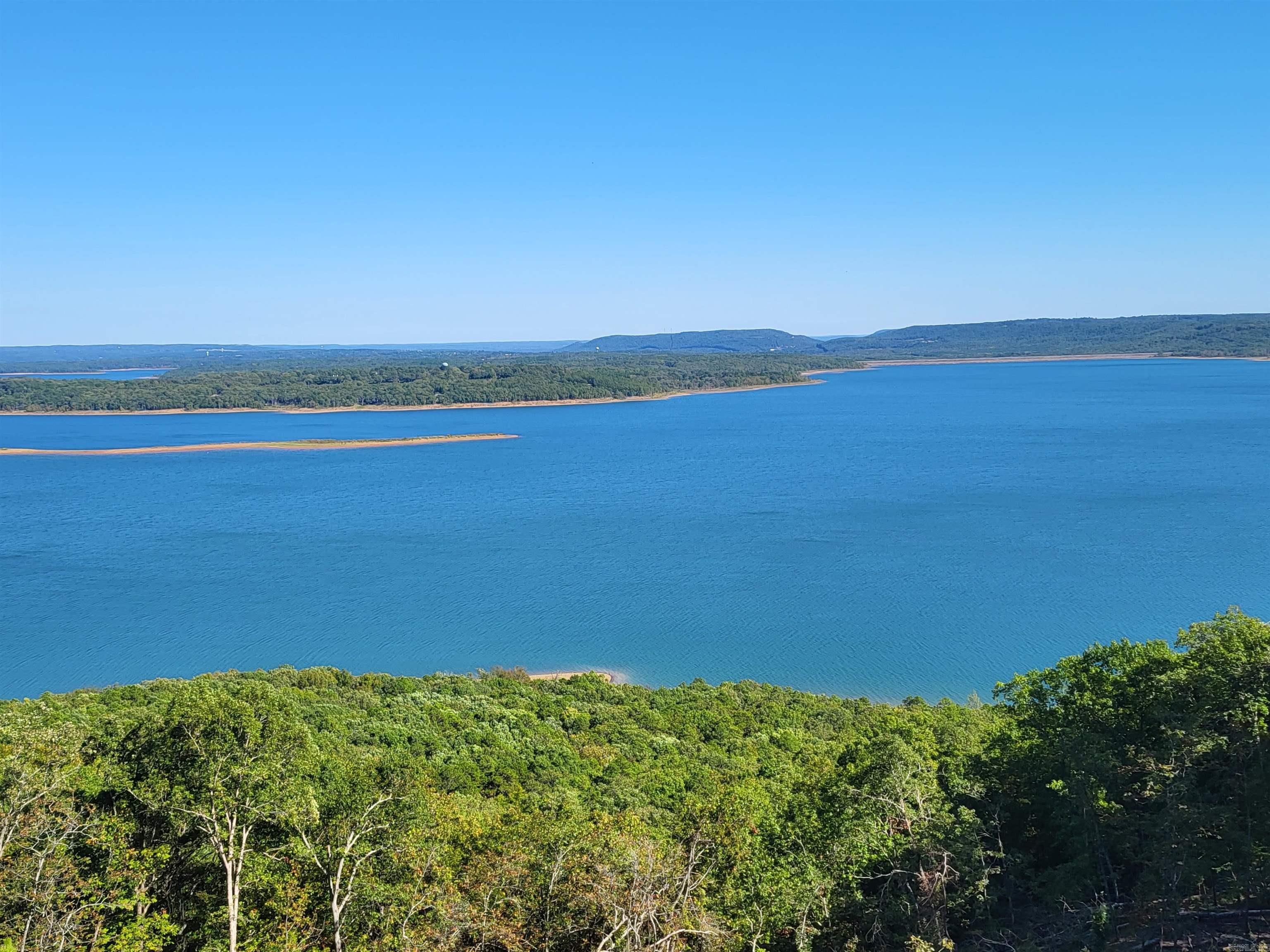 Fabulous Lake frontage of 859.45 feet and spectacular views on high bluff. Excellent home site. Large trees. Adjacent Tract 19 available. Deed restrictions. Seller financing of 10% down, 20 years at 8%. Detailed brochure. Paved county rd. Fiber optic cable internet. Public water, electric, phone, septic. All proceeds go to a Charitable Trust. This is the very best tract on Greers Ferry Lake! See drone video attached and other videos plus photos.