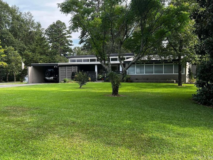 **AGENT OWNED** This one of a kind Mid Century home has been lovingly restored and is full of original character while providing modern conveniences. Through its' years long transformation, all 29 new windows have been replaced, providing upgraded energy efficiency. All new floors, lighting, ceiling fans, tongue and groove ceilings, brand new bathrooms, solid European Walnut butcher block countertops and all new appliances equip this home with a cozy updated look. The vaulted ceilings, operational transoms and skylight windows allow for tons of natural light and spaciousness. The stand alone center fireplace is the focal point of the family room and provides the home with ambiance and warmth during those cold winter months. Mid Century style fencing and woodwork add to the curb appeal and gives complete privacy to the backyard and relaxing back porch. This home sits on over 1 acre of mature trees, fruit trees and beautiful landscaping. There are two outside storage options to fit anyones needs.