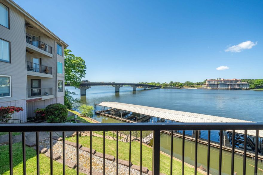 Welcome to lakeside living at its finest! This completely updated condo offers an impressive 1,648 sq. ft. of sophisticated living space with 2 BR's and 2 BA's. The moment you step inside, you'll be captivated by the breathtaking lake views. This unit showcases modern finishes and thoughtful design throughout. The living area flows seamlessly to a balcony where you can sip your morning coffee while watching the sunrise over the water. As a lakefront property, you'll enjoy the convenience of your own covered boat slip—perfect for spontaneous adventures on the water without the hassle of launching your boat. Plus, remote control Boat lift valued at $15,000.00 that will convey with Condo as well. Imagine ending your day with a sunset cruise just steps from your door! Investors take note—this property presents exceptional potential as a short-term rental destination, attracting visitors year-round who seek a waterfront getaway with stunning views and direct lake access. Experience the joy of lakeside living where every day feels like vacation in this thoughtfully updated condo with panoramic water views.