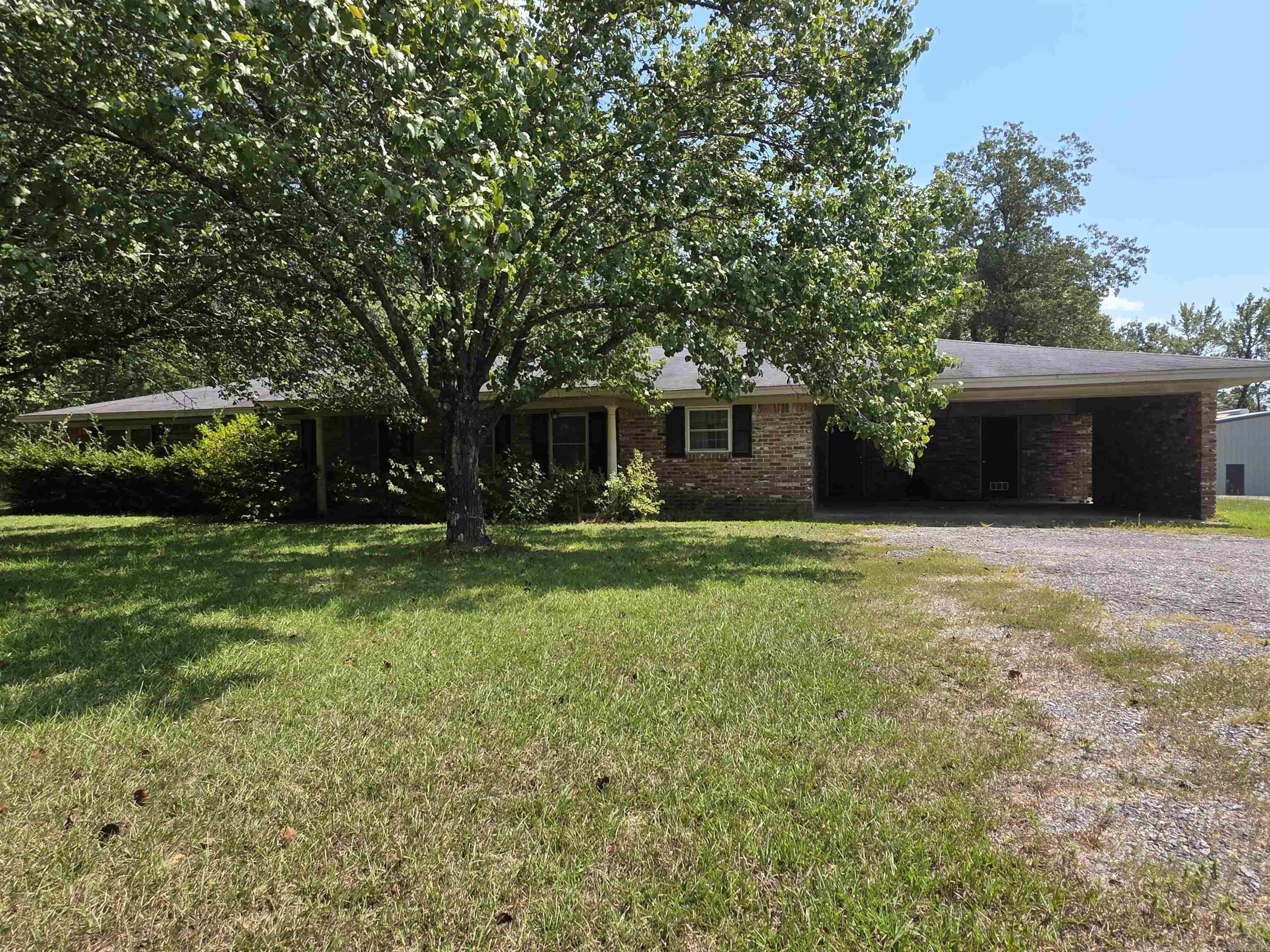 Country living close to town! This is a very well maintained home with a country flair sitting on a spacious 1.7 +/- acres. It has a fully fenced back yard and covered back patio. The rooms are spacious and has an open floor plan. Plenty of shade here and opportunity for relaxation! Additional acreage and amenities may be available. Give me a call to take a look. Final acreage and legal description will be determined with a survey prior to closing.