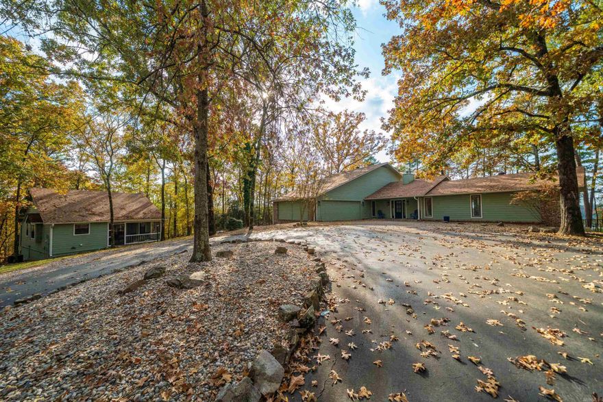 Presenting a rare opportunity to own two exceptional homes, sold fully turn-key, on 2.78 acres of beautifully manicured, unrestricted lakefront property. This remarkable estate blends privacy, luxury, and unmatched versatility, set along 100 feet of pristine shoreline with serene views and direct water access. The main residence offers 2,423 sq. ft. of refined living space, featuring 3 spacious bedrooms,3.5 baths, and a dedicated office currently being used as a fourth bedroom. Thoughtfully designed for comfort and entertaining, it provides an inviting atmosphere for memorable lakefront living and comfortably hosts gatherings of family and friends. The charming guest house adds another 880 sq. ft. with 1 bedroom, 1 bath, and a bright, airy sunroom that offers additional sleeping space. Perfect for extended family, guests, or multi-generational living, it delivers exceptional flexibility. With no property restrictions, there is even potential to add an additional small home to further enhance the estate. Outdoors, the property truly shines with an inground pool, hot tub, firepit, and a floating covered boat slip—everything desired for an effortless lake lifestyle.