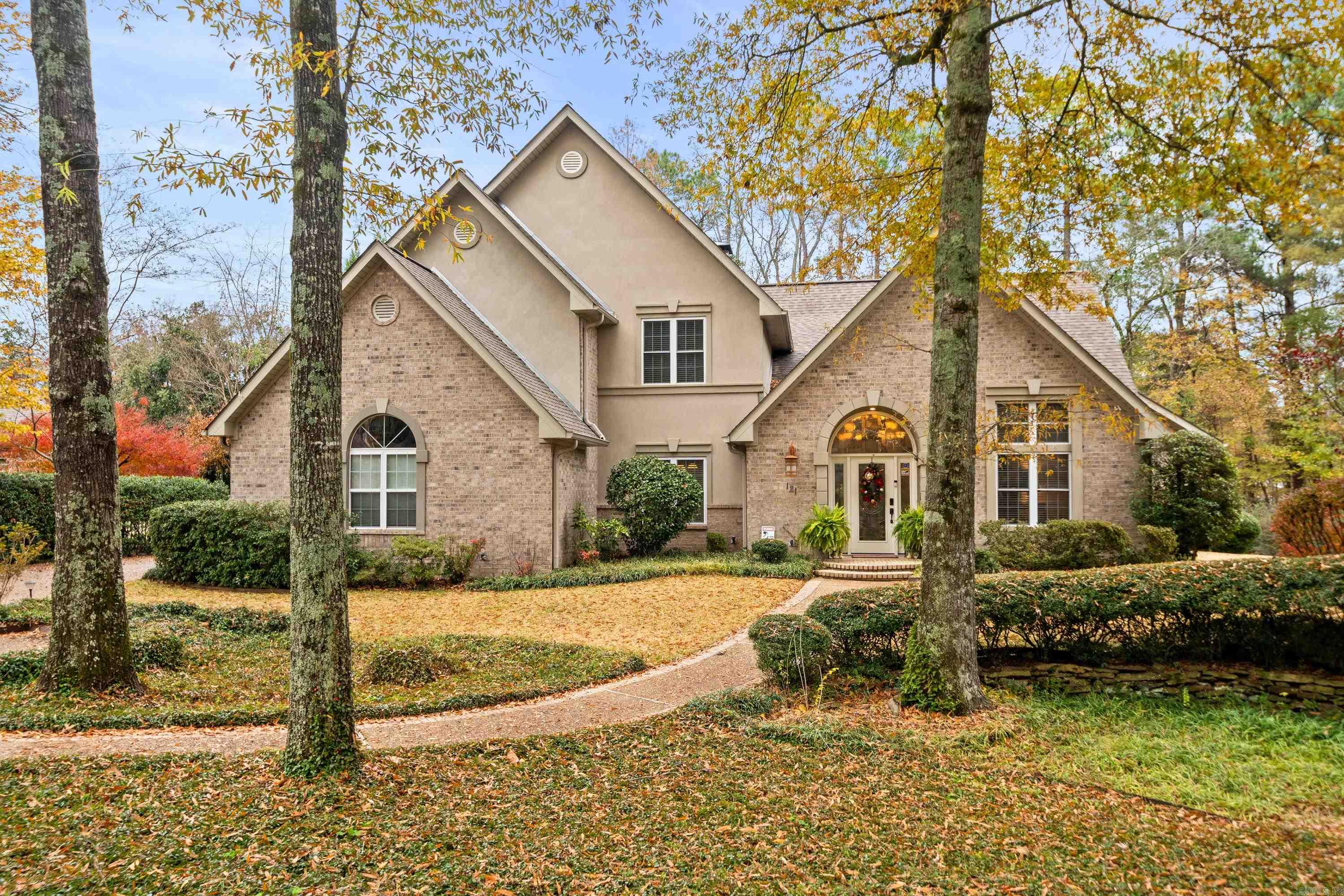 Welcome to 121 Lotus Loop, a truly beautiful home that perfectly combines modern updates with timeless elegance. This spacious residence offers 5 bedrooms and 4.5 bathrooms, making it ideal for both everyday living and entertaining. Enjoy the convenience of a main-floor primary suite, thoughtfully designed for privacy and relaxation. The heart of the home features a living room with vaulted ceilings, skylights that flood the space with natural light, a cozy fireplace, and a wet barāperfect for entertaining. The kitchen is a standout feature, now upgraded with brand-new countertops that elevate its modern appeal. It also includes an oversized island with a sink, top-of-the-line appliances, and plenty of prep and storage space. Adjacent, you'll find an eat-in kitchen area and a separate formal dining room for larger gatherings. The second floor offers plenty of room for family or guests, with 4 generously sized bedrooms and 3full bathrooms. Step outside to unwind on the private back porch or the side porch, both offering peaceful spots for relaxation. End your day in the luxurious hot tub, a perfect retreat after a long day.
