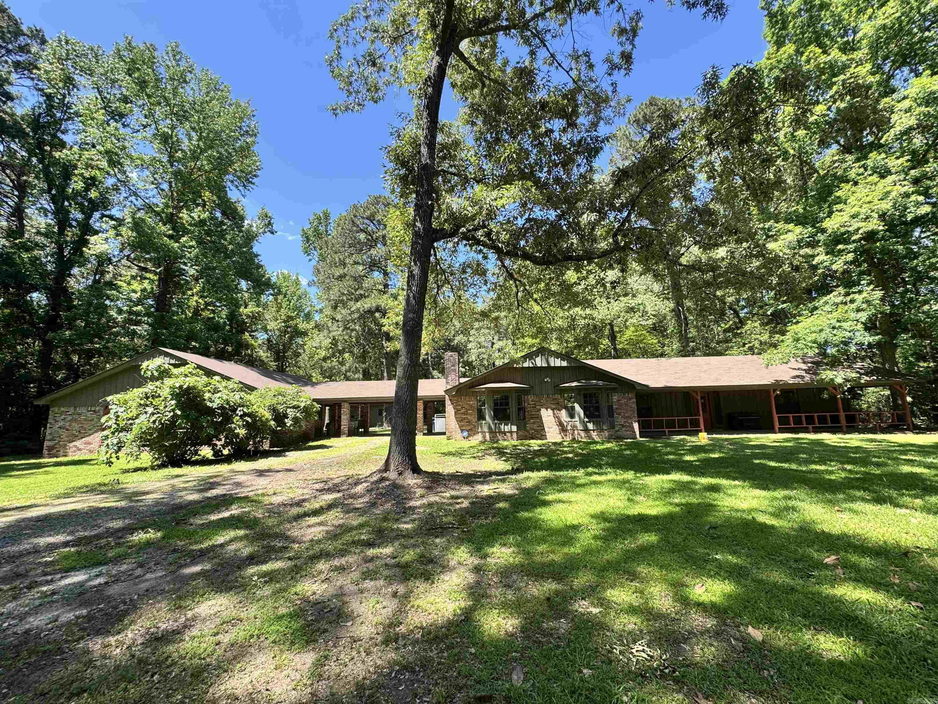 Welcome to this beautifully updated 3,599 sq ft home featuring 4 bedrooms, 3 bathrooms, and modern touches throughout—granite counter tops, laminate/tile flooring, and a wood-burning fireplace. The open layout includes a formal living room, family room, office/study, and in-law quarters. Enjoy extra space with a 1-bed, 1-bath garage apartment (701 sq ft), ideal for guests or rental income. A large, detached workshop also included- offering flexibility for hobbies or work!! Set on 5+ peaceful acres with a mix of wooded and cleared areas, the property includes a porch, guest house, and 2-car carport. Country living with easy access to town. Don't wait- schedule a walk-through of this must-see property today! Seller Motivated!
