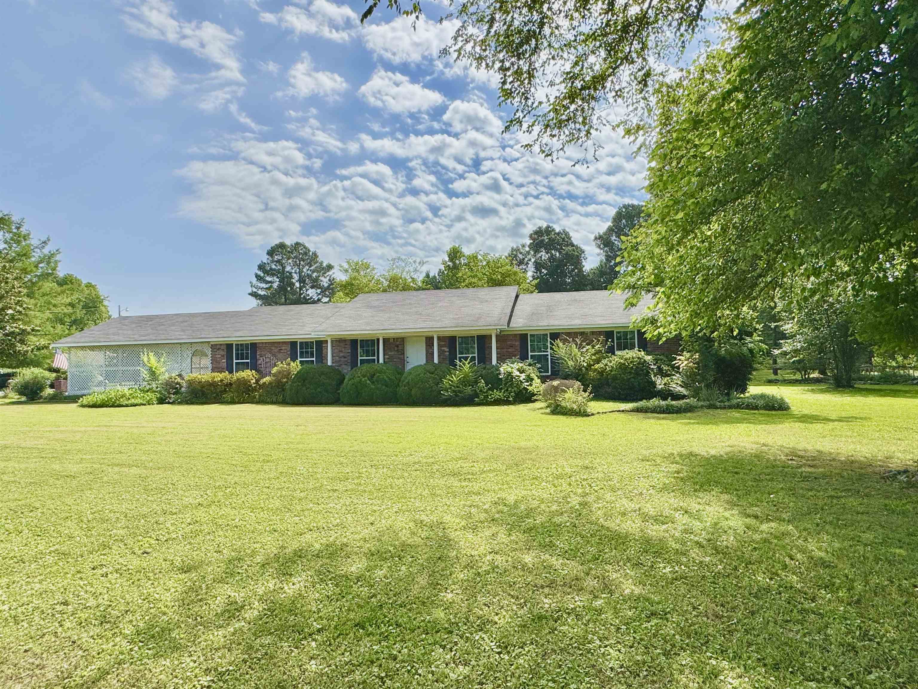 Step into comfort and style with this beautifully remodeled brick home sitting on 3 lots. Inside, the open floor plan is both welcoming and functional. The kitchen has brand-new cabinetry, stainless steel appliances, a breakfast bar, and a formal dining area—ideal for entertaining. The living area has a woodburning fireplace as well as access to the large back deck! The master suite includes a full bathroom with a walk in tile shower, while the guest bedrooms are very spacious. Bonus spaces include an office/sitting room and a den, offering flexibility for work-from-home needs, hobbies, or additional living space. The oversized laundry room features additional storage and direct outdoor access, making it a convenient mudroom. Surrounded by beautiful landscaping and mature trees, this property offers a beautiful outdoor space. A storage building and gardening shed add practicality, while the yard features a concrete pad—perfect for building a workshop or even a secondary home along with room for an RV. There is also an oversized 2 vehicle carport. This turnkey property is a must-see, located near all local attractions!
