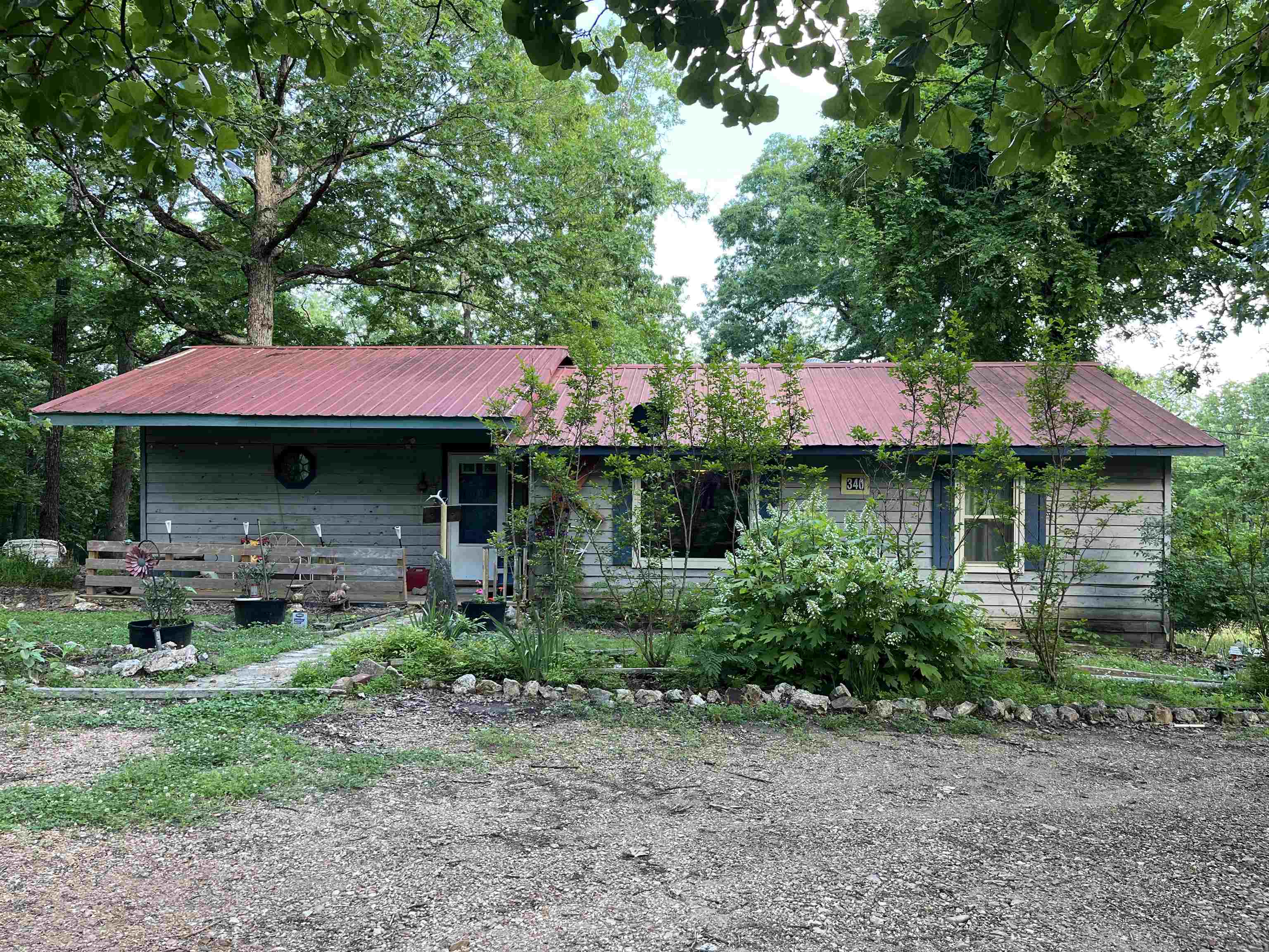 Spacious country home! This country home on 2.74 acres of wooded land has been owned by the same owners for 30 years but now is time for the next family to call it home. It is currently a 2 bed-2bath home but has plenty of space to be modified for additional bedrooms. Large open kitchen with breakfast bar provides ample space for family gatherings. Then move everyone into a large living room with a beautiful custom built fireplace and lots of large custom windows. When the gang has gone home, you relax on the back deck and enjoy the quietness of the country. The property also offers a 24x30 detached garage with concrete slab that could be a handy man's dream. I hear there is even a wet weather spring on the back side of the property if you want to check it out.