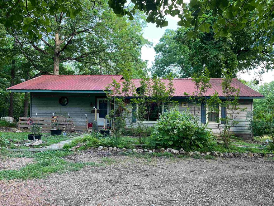Spacious country home! This country home on 2.74 acres of wooded land has been owned by the same owners for 30 years but now is time for the next family to call it home. It is currently a 2 bed-2bath home but has plenty of space to be modified for additional bedrooms. Large open kitchen with breakfast bar provides ample space for family gatherings. Then move everyone into a large living room with a beautiful custom built fireplace and lots of large custom windows. When the gang has gone home, you relax on the back deck and enjoy the quietness of the country. The property also offers a 24x30 detached garage with concrete slab that could be a handy man's dream. I hear there is even a wet weather spring on the back side of the property if you want to check it out.