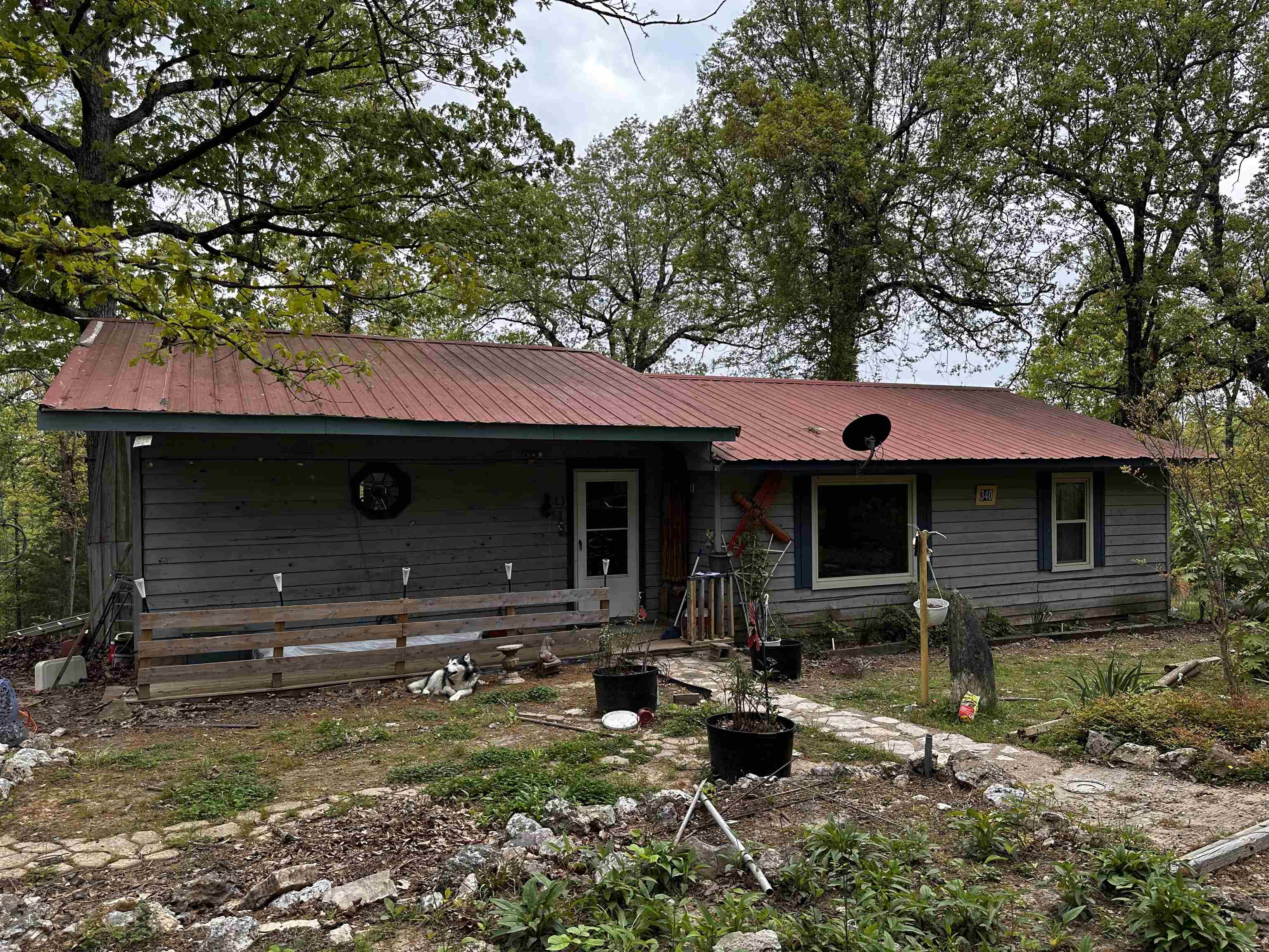 Spacious country home! This country home on 2.74 acres of wooded land has been owned by the same owners for 30 years but now is time for the next family to call it home. It is currently a 2 bed-2bath home but has plenty of space to be modified for additional bedrooms. Large open kitchen with breakfast bar provides ample space for family gatherings. Then move everyone into a large living room with a beautiful custom built fireplace and lots of large custom windows. When the gang has gone home, you relax on the back deck and enjoy the quietness of the country. The property also offers a 24x30 detached garage with concrete slab that could be a handy man's dream. I hear there is even a wet weather spring on the back side of the property if you want to check it out.