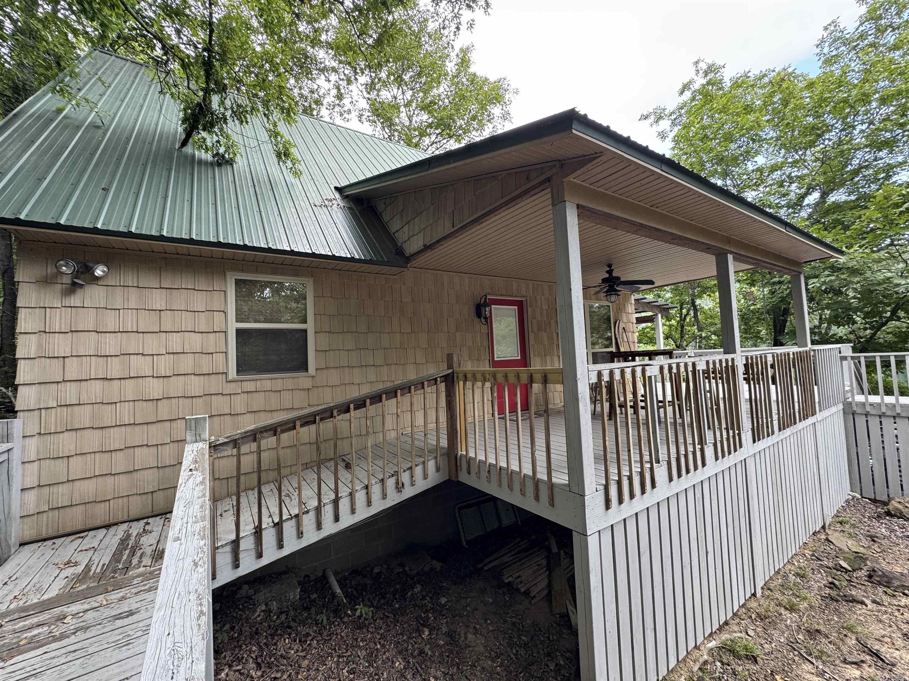 Wow what a great home sitting right on the water! Beautiful tongue & groove wood ceiling and wood floors. Kitchen has drop in smooth top convection range, dishwasher & refrigerator ( all appliances stainless steel ). Living room has a view of the lake and a wood burning stove. Huge back deck for entertaining or just sitting in the porch swing and watching the boats go by. Most furniture and furnishings stay with home. Steps going to the water. Great for full time or weekend. Give us a call today.