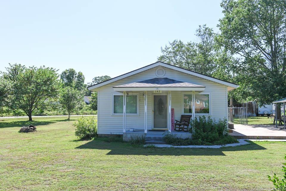 This remodeled two bedroom/1 bathroom home is one of the cutest in the area. It features newer wiring, windows, HVAC (2020), roof (2024), bathroom remodel, new appliances, flooring, a new garage, a new deck, and a new paved/concrete driveway. The home sits on a corner lot and has two carports, an outbuilding and a chicken coop.