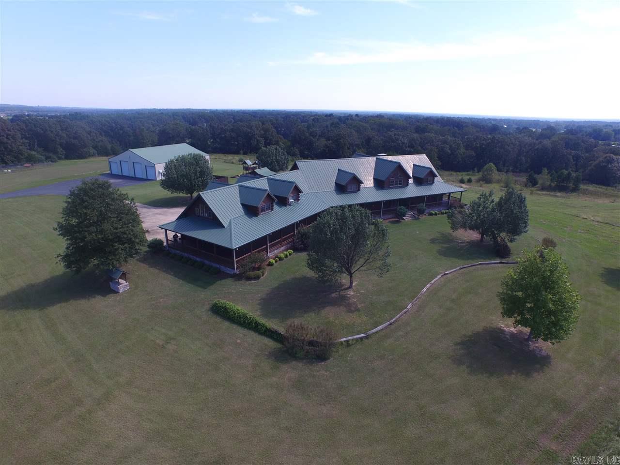 Country estate, lodge-style manor.  This home has over 6000 sq. ft. with 35+- acres.  The house has 1300 sq. ft. apartment over the 4 car garage.  Heated ceramic tile floors, floor to ceiling rock fireplaces. KitchenAid appliances with a Sub-zero fridge.  Master bed has a spiral staircase to the loft, a glass block shower and an access to the basement from the closet.  20x40 swimming pool with pool storage.  Baseball field, pond, golf tee and 70x70, 5000 sq. ft. shop.  Sq. ft. approx. measuring encouraged.