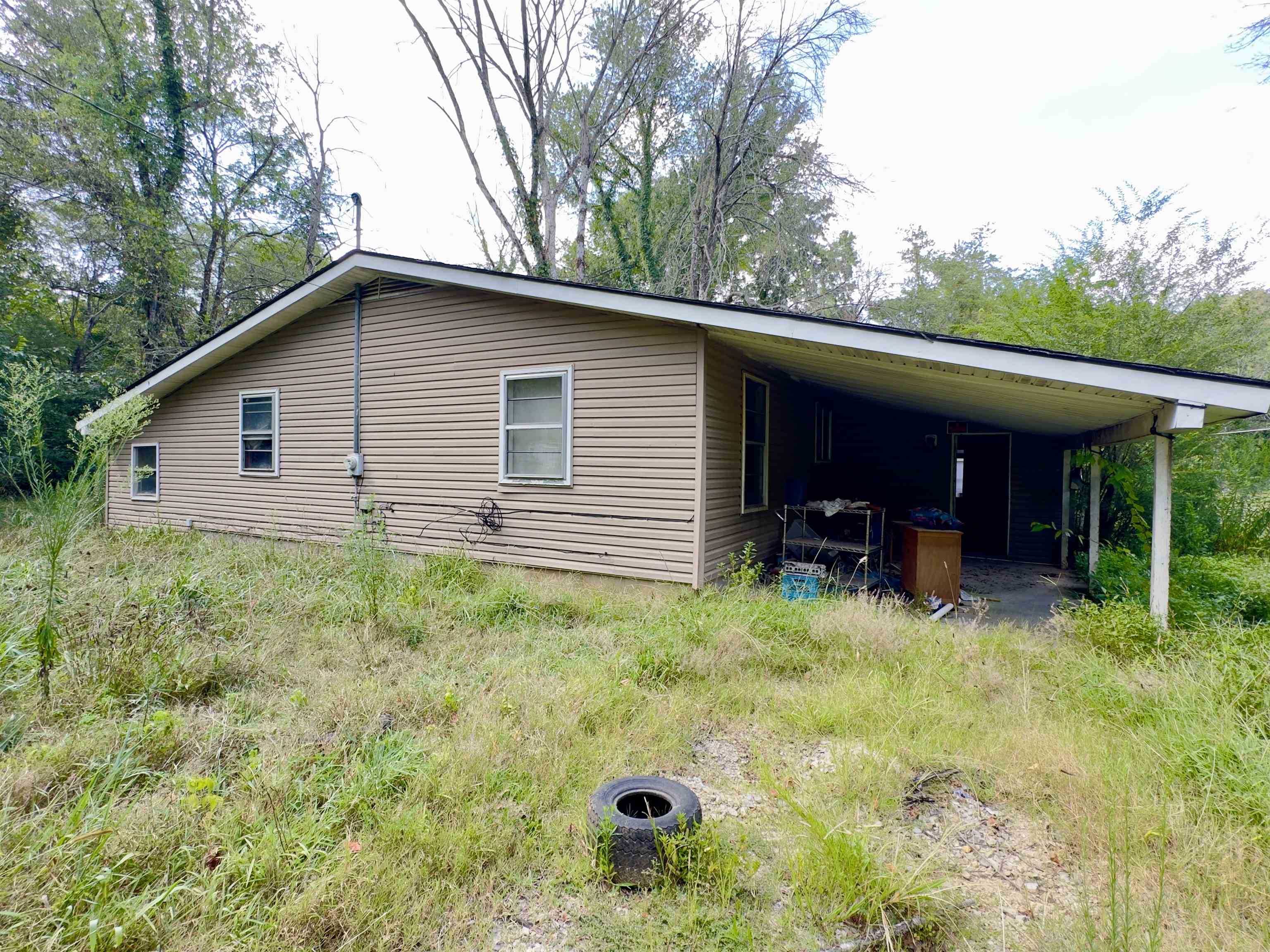 Home sits on 5 beautiful level lots in the Spring River community of Rio Vista II in Hardy Arkansas! Various fully mature trees are spread throughout the property providing a park like setting. This being such a close distance to the river where people love to swim, float and fish make this location a sweet spot for those who love the outdoors! While this home was once a gem, deferred maintenance, flooding and neglect have placed it in the position of being sold AS IS WHERE IS WITH ALL FAULTS and at a price that will make it worth it for the new owner who is ready and able to take advantage!
