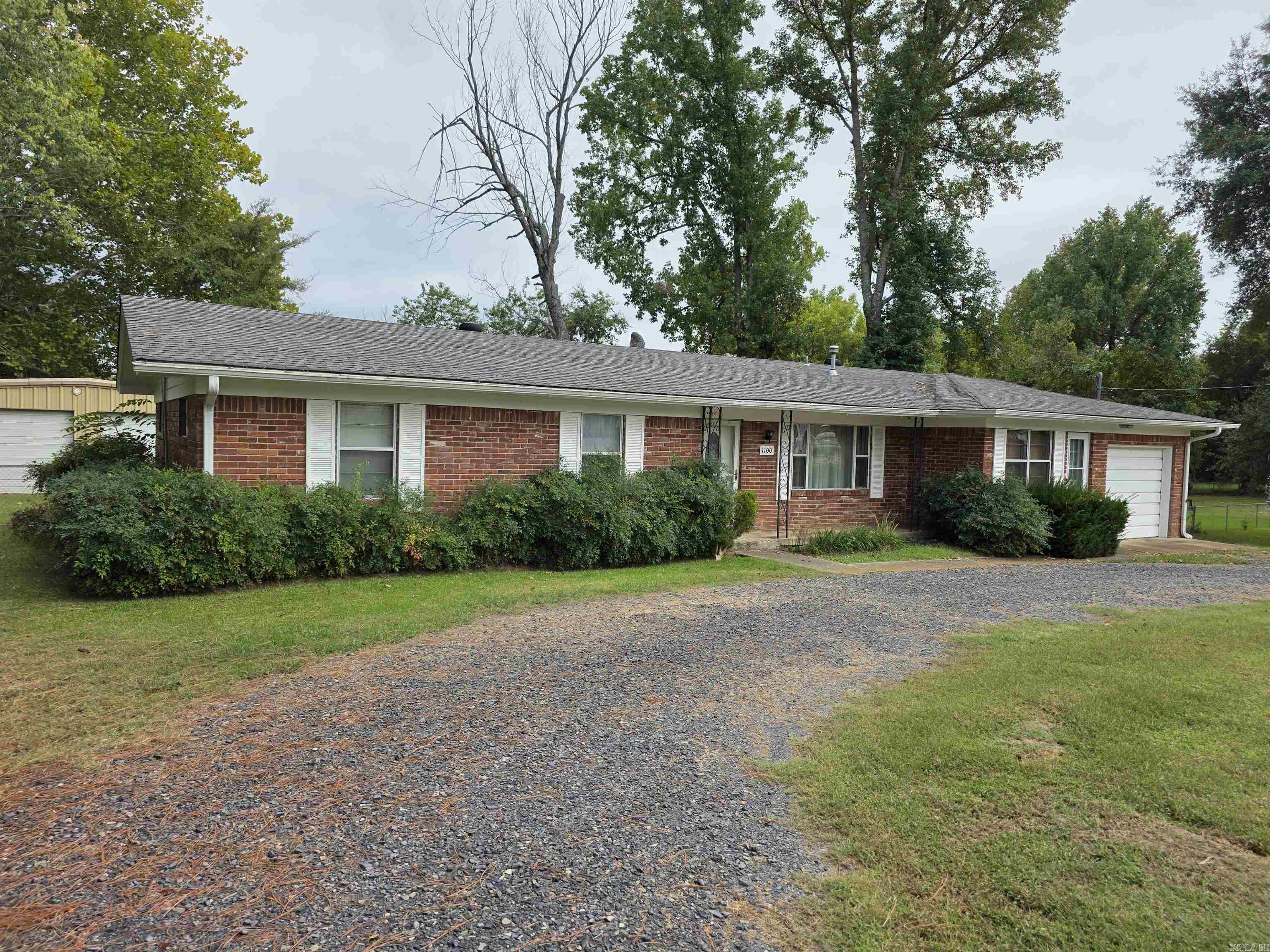Neat brick home with setback from street and circle drive. Fenced back yard & a shop too! Interior has had new paint and flooring, gas cook top, regrigerator stays, pellet stove in the spacious living room. A sun room with a tile floor is the perfect place for your plants! One-car enclosed garage with automatic opener. Laundry room with built-ins, bathroom also has a laundry chute! This home is ready for you to move in!