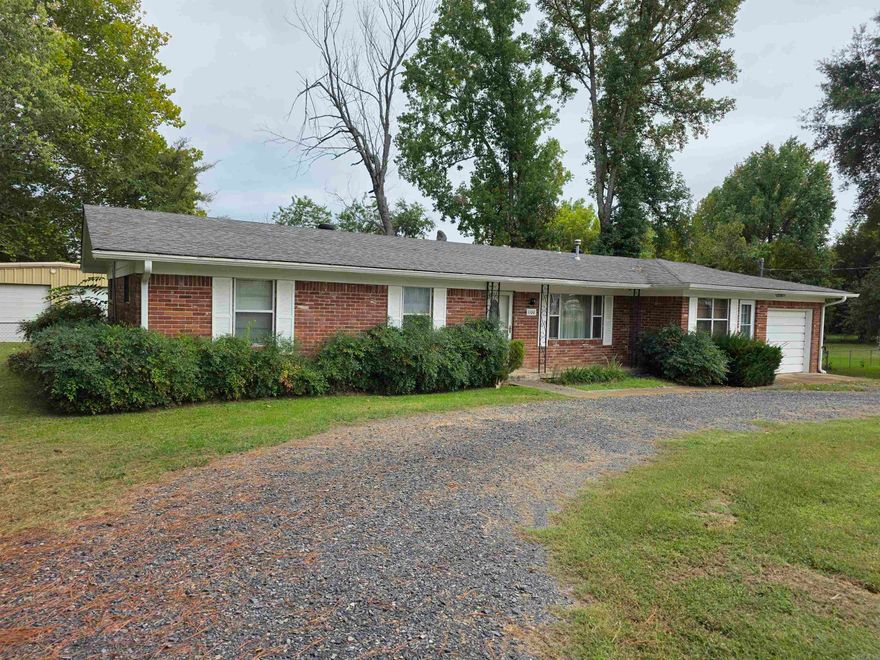 Neat brick home with setback from street and circle drive. Fenced back yard & a shop too! Interior has had new paint and flooring, gas cook top, regrigerator stays, pellet stove in the spacious living room. A sun room with a tile floor is the perfect place for your plants! One-car enclosed garage with automatic opener. Laundry room with built-ins, bathroom also has a laundry chute! This home is ready for you to move in!