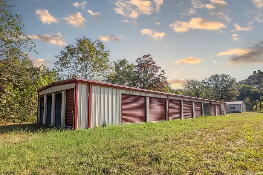 24-Unit Mini-Storage Facility with Expansion Potential – Hardy, AR Just 5 miles outside Hardy, Arkansas, this newly built 24-unit mini-storage facility offers a rare investment opportunity with prime highway frontage and 16 acres of land. The property blends cleared ground with natural timber, including white oak and hardwoods, plus a creek along the backside—ideal for both beauty and expansion.  The facility has never been rented, making it turnkey for a new owner. It includes 16 large units and 8 smaller units, perfect for residential or overflow storage needs. A 30x30 shop building with a bathroom provides options for an office, workshop, or additional rental income. The property is partially fenced with a gated entrance for secure access, and the mostly flat terrain makes further development practical.  With nearly half the acreage already cleared and the rest in timber, the land is perfectly set up for adding more units or other income-producing amenities. This Hardy-area property is more than a storage business—it’s a flexible, high-potential investment ready for growth.