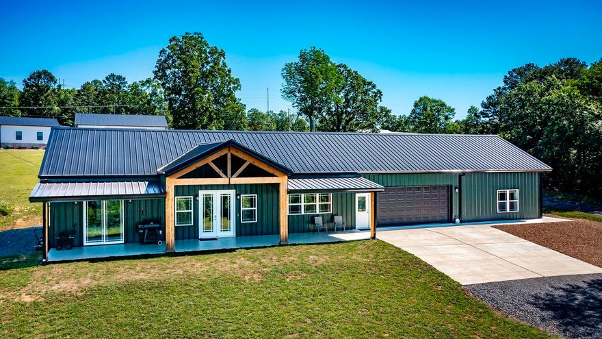 Discover your dream country retreat near Greers Ferry Lake. This stunning custom-built home features a private mother-in-law’s quarters. This home sits on nearly six acres overlooking Greers Ferry Lake. The main residence features 3 bedrooms, 2 bathrooms, and approximately 1,550 sq. ft. of energy-efficient living space thanks to spray foam insulation. At the heart of the home is a massive 9’x5’ quartz kitchen island which seats 8–10, perfect for entertaining. Custom cabinets provide a modern yet rustic aesthetic that is both durable and stylish. The property includes a 30’x30’ heated and cooled garage with epoxy floors—ideal for a gym, workshop, boat storage or large vehicles. For mother-in-law, guests or rental income, a separate 550 sq. ft. apartment includes a separate entrance with an additional living room, bedroom, bathroom, full kitchen & washer & dryer. Whether you’re looking for a multi-generational setup or a hobbyist’s paradise, this estate delivers. Located 2 minutes from premier boating, fishing, and lake recreation, this unique property combines high-quality construction with the peaceful lifestyle you’ve been searching for. Don’t miss this one-of-a-kind lakeside gem!