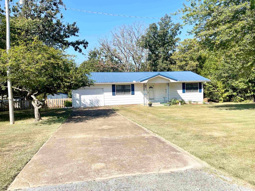Charming 2-Bed, 1.5-Bath Home for Sale in Horseshoe Bend, AR – 205 N Bend Drive Nestled in the serene community of Horseshoe Bend, Arkansas, this beautifully maintained 2-bedroom, 1.5-bathroom home is perfect for a new owner.  With a new metal roof and gutters installed in 2021, this home is move-in ready and built to last. Step inside to find durable vinyl plank flooring throughout, providing both style and easy maintenance. The cozy living room features a gas fireplace, creating a warm and inviting space to unwind. The modern kitchen boasts upgraded appliances (2022), including a stainless steel side-by-side refrigerator, smooth top electric cookstove and microwave and beautiful countertops! A new sliding glass door opens to a spacious back deck, perfect for relaxing outdoors or entertaining friends. The home is equipped with insulated windows and doors, plus a regularly serviced HVAC system, ensuring energy efficiency and comfort year-round. A brand new wooden fenced in back yard for your doggies is also a bonus.  Located in a friendly neighborhood near the amenities of Horseshoe Bend—including lakes, golf courses, and local shops.