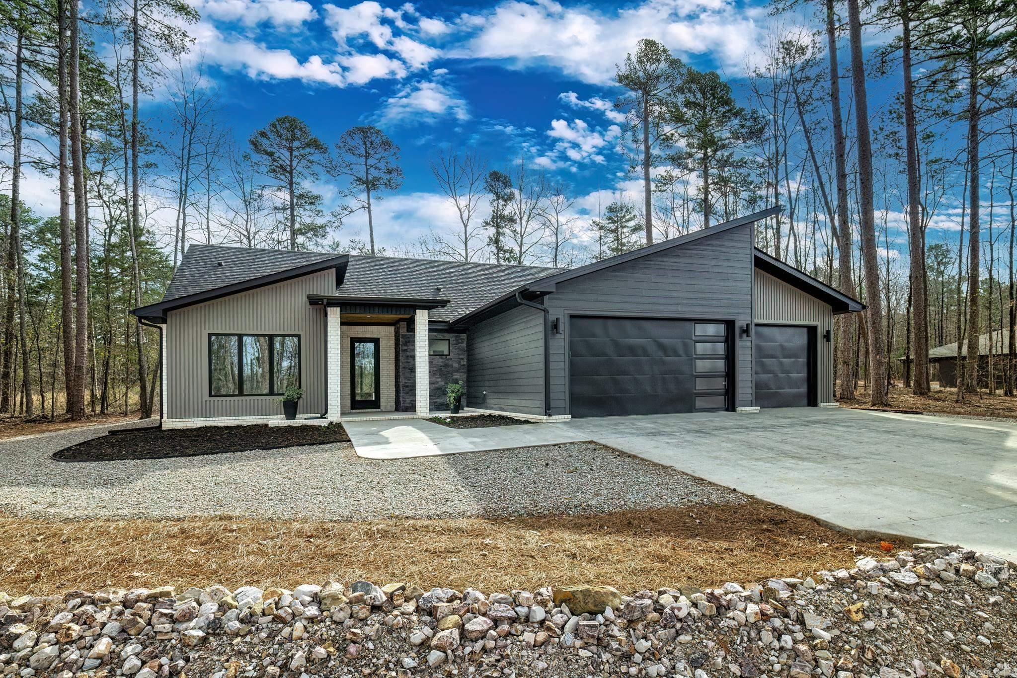 Brand new never lived in home. Seller has to move due to new job. She never even moved in!! You will find impressive upgrades in this sure to please home. From the cedar lined ceiling on front porch to the cedar ceiling on the patio expect nothing but excellence. Designer light fixtures and hardware throughout. In the kitchen you will enjoy upgraded granite counters and added cabinetry including a well designed pantry with two outlets. For the chef in the family there is a sought after gas stove with a griddle. Note the oversized island perfect for entertaining. Great room features a stunning gas fireplace with surrounding cabinetry and shelving. The spacious primary suite has tray ceiling, oversized counter and large walk in shower, more than ample closet and access to patio where you can enjoy your morning coffee in your peaceful surroundings. Comes with buildable vacant lot next door. Hot Springs Village is a 26,000-acre gated community with 11 lakes, 9 golf courses, white sand beach, hiking trails, pickle ball, fitness center, indoor and outdoor pool, tennis and SO MUCH MORE. One time POA buy-in fee $2000 due at closing. Taxes are on vacant land