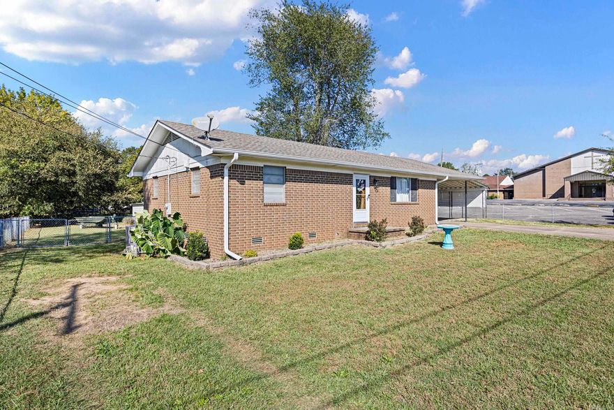 This home is centrally located, close to the downtown shopping district, yet the park-like backyard makes it seem secluded. This cozy 2-bedroom, one-bath home has been updated with new HVAC, DISHWASHER, GUTTERS, FLOORING IN BEDROOMS, and CEILING FANS. Sit on the covered back deck and enjoy the cool mornings or evenings. There is a fire ring for roasting hot dogs and making s'mores! The backyard is chain-fenced, and there is a large storage building to store your treasures. There are many other updates, but you must see them in person to appreciate them.