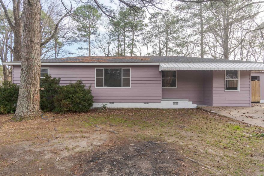 Maintained 2 bedroom with extra space for third bedroom or bonus room. Inside includes fresh paint with dark stained wood floors and a large laundry room with plenty of storage. Outside you will find a covered patio, extra storage room and large fenced back yard. Roof is only one year old, HVAC is 3 years old. Great for a primary residence or investment property. Agents please see remarks.