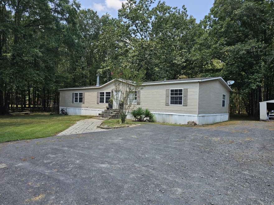 Don’t miss the opportunity to have your own little slice of the country lifestyle. Double wide mobile home on permanent foundation, with just over 3 mostly wooded acres! Two story workshop, wired for 220 volts for all of your tools and projects. Huge deck that is great for entertaining, or sitting quietly while  enjoying being surrounded by  nature whenever you feel like it! FIVE BEDROOMS AND 3 BATHROOMS! New microwave has recently been installed and  new carpet to be installed soon in the primary bedroom. Cypress Bayou WMA is less than half a mile from the front door step! This property can be bought as a package deal with MLS# 24028232  (next door)