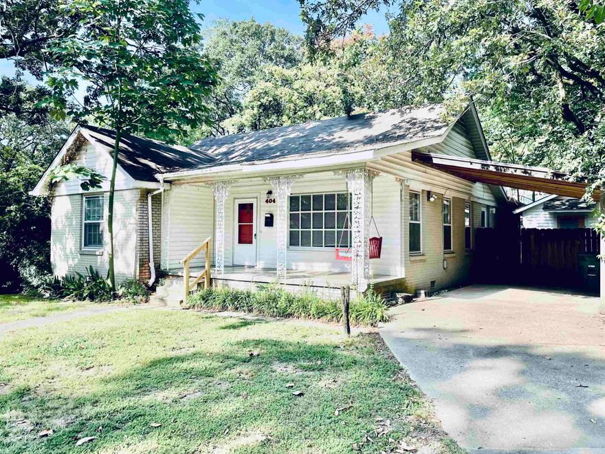 Cute Hillcrest cottage with hardwoods, front porch with red porch swing, covered carport & 2 storage rooms: one, a large workshop/craft room/rec room, another smaller, separate one has an additional fridge. Fridge, gas stove & dishwasher in Saltillo tiled eat-in large kitchen. 2 bedrooms with full bath with tub-shower combo in-between in front area, back bedroom with full bath has standup shower. all bedrooms have 2 windows & Ceiling fans. Rock Fire pit & charcoal grill in shaded, fenced level yard. Flagstone patio in back, concrete patio off kitchen. Full sized Washer & dryer connections in hall closet. If renter doesn't have their own, washer & dryer available. Decorative FP with mantle, large picture window in living with 2 additional windows let natural light stream in. Separate dining. Walk to neighborhood grocery, boutiques & cafes.