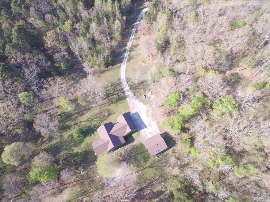 HIDDEN GEM ON 4.43 ACRES!  THIS ALL- BRICK SINGLE LEVEL HOME WITH 9 FOOT CEILINGS, OFFERS 3 BEDROOMS (POTENTIAL 4TH) AND 2-1/2 BATHS WITH AN OPEN, INVITING FLOOR PLAN.  ENJOY A BRIGHT SUNROOM, SPACIOUS LIVING AREAS, FIRE PLACE WITH GAS LOGS, AND A WELL- EQUIPPED KITCHEN WITH STAINLESS STEEL APPLIANCES, GAS COOK TOP, ALL WHICH IS PERFECT FOR ENTERTAINING.  THE PROPERTY INCLUDES A AUTO-STANDBY GENERATOR FOR PEACE OF MIND AN A SEPERATE SHOP IDEAL FOR PROJECTS OR STORAGE.  SURROUNDED BY PRIVACY AND SPACE, THIS HOME BLENDS COMFORT, FUNTIONALITY, AND COUNTRY CHARM--PERFECT FOR THOSE SEEKING ROOM TO LIVE, WORK AND RELAX.