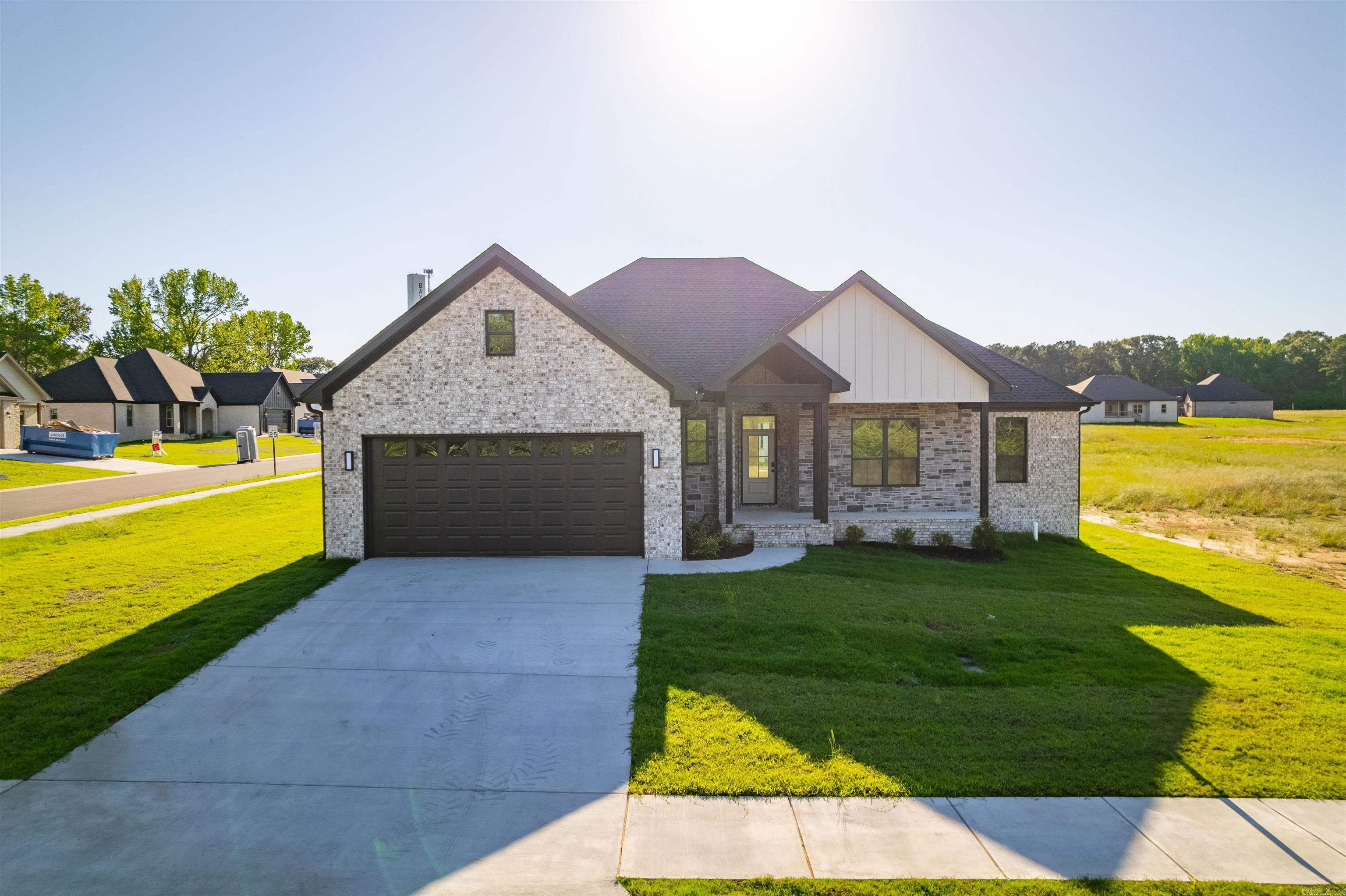 Welcome to style and elegance in this 2025 New Construction Home! Approaching the home you notice the stained front porch ceiling & solid 6x6 posts creating an instant feel of charm and rugged elegance. Entering the home you step into the foyer greeted by the spacious living room accenting the ultra open concept of this stunning home! Immediately you notice the custom blend of lights and darks with subtle hints of rugged style like the blonde beams in the living room, custom fireplace trim, and the perfectly accented ventahood. The large kitchen w/hidden pantry + large bar top island allows for entertaining guests and convenient family nights. Just off the kitchen is the dining / breakfast area. This home boasts a split floor plan with guest bedrooms on the right and the master bedroom and custom master bath on the left - go see this bathroom! The home boasts a spacious laundry & mud room too! Enjoy covered front & back porch time with this home too! The home has tile and luxury vinyl & hybrid laminate throughout the home. Seller is Offering $5K towards Buyers Closing Costs! Do not miss out on this deal! See Agent Remarks.