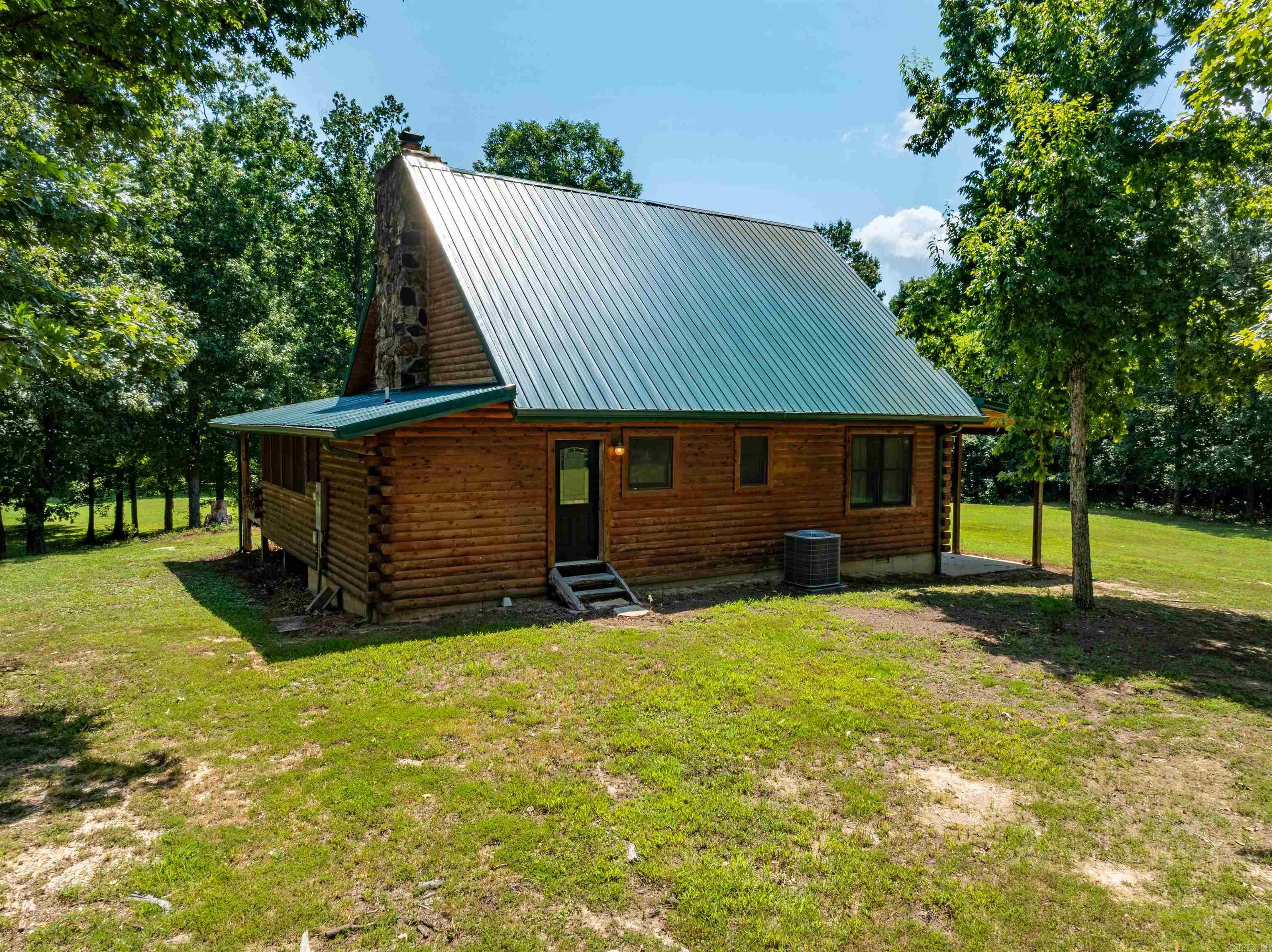 Turnkey Custom Log Cabin on 4.75± Acres ā Riverfront on the Current River | Maynard, AR 2 Bed | 2 Bath | Vaulted Ceilings | Screened Porch | No Flood Insurance Required (Per Seller) This move-in-ready custom log cabin sits on 4.75± secluded acres at the end of a private road with direct Current River frontage near Maynard in Randolph County. Enjoy total privacy, upscale rustic charm, and peaceful river views with no flood insurance required (per seller). The cabin features 2 bedrooms, 2 baths, a vaulted great room with exposed beams, floor-to-ceiling stone fireplace, and custom knotty alder cabinetry. The kitchen is beautifully finished with granite countertops, copper farm sink, and black stainless appliances. You'll love the screened-in porch with a second fireplace, perfect for watching wildlife year-round. Also includes a loft sleeping area, elegant lighting, laundry room, and covered back deck overlooking the wooded landscape and river. Truly turnkey and ideal for a vacation home, full-time residence, or short-term rental. Fully furnished with acceptable offer (with exception of 1 bedroom set, safe and Ā log furniture on front porch)!! Ā Just Bring Your Clothes!!!