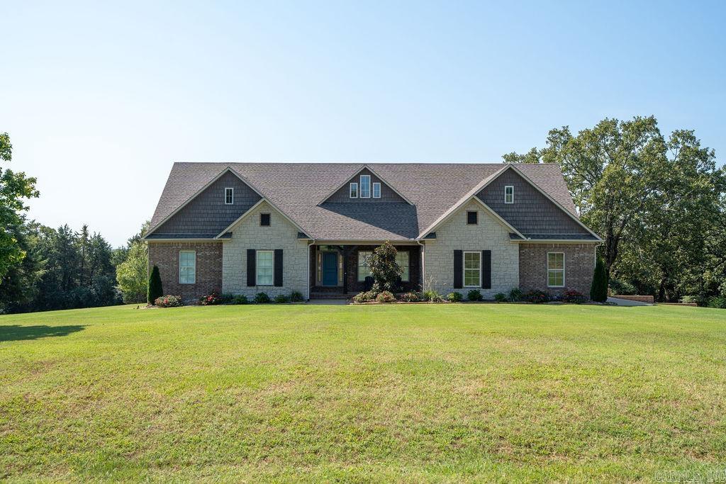 Immaculate custom built home in the Woodridge subdivision sitting on 5.35 acres. This home features 3 bedrooms, 2 1/2 baths, with all new appliances, counters and backsplash in the kitchen, all newly painted throughout, new flooring, plantation shudders and new door inserts with blinds, all new receptacles, LED lights and fans, new hot water heaters. Storm shelter is new and recently cleaned. Nice 40'x60' fully insulated shop with electric, gas heat and 1/2 bath, with 12'x16' overhang and 3 bay doors. Extra 32'x18' barn with electric, water and additional storage space. Enjoy you afternoon on the newly treated spacious deck with a wood burning fireplace, ceiling fans and built-in seating. 2 Car garage is fully insulated with easy stair access to the completely decked attic. Additional storage under the house with crawl space access. All the work has been done and home is move-in ready!! Come take a look!!