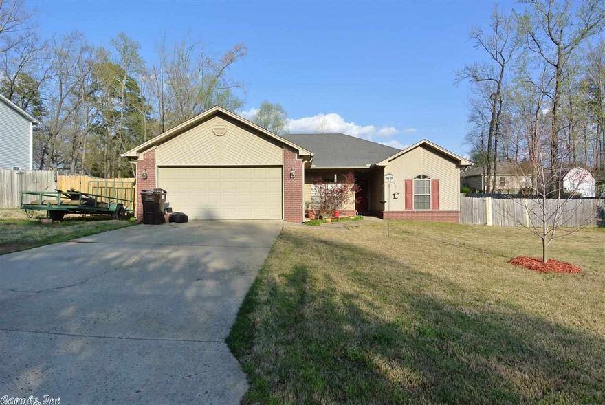 This adorable starter home is very well maintained! Hardwoods, tile in wet areas, fireplace in great room, trey ceilings, recessed lights, ceiling fans, master suite sets apart and has 3 closets! Large master bath has his/her vanities, separate whirlpool tub & shower, large walk in closet. All bedrooms are  good sized, eat in kitchen with gas range & custom cabinets.  A very large fully fenced  back yard.   Brand new Carrier AC and heat unit, gutters, patio on back.  Great location! Bryant Schools!