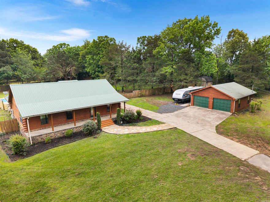 Fully remodeled log cabin home on 1.69 acres with an in-ground pool! This 4-bed/2-bath home offers 1,891 sq. ft. of beautifully updated living space, blending rustic charm with modern finishes. Interior upgrades completed in 2026 include all new flooring, fresh paint throughout(including walls, trim, cabinets, & ceilings), newly stained log walls, updated lighting with adjustable settings, added crown molding, new ceiling fans, and stylish finishes throughout. Both function and comfort shine with updated bathrm fixtures, new blinds, & upgraded hardware in every room. Step outside to enjoy a freshly stained and sealed exterior, updated doors with new hardware, enhanced lighting, and a welcoming front porch with new ceiling fans. The property is flanked w/ green space & fully fenced backyard. From the pergola you can enjoy the refreshed in-ground pool that has a new liner, diving board, & equipment updates, plus a newer pump (2023). Add. highlights include a 2-car garage with added lighting, a new RV pad w/ 30-amp hookup, and a storage shed nearby. This move-in ready property offers the perfect mix of peaceful acreage, modern updates, and outdoor living-don't miss it!