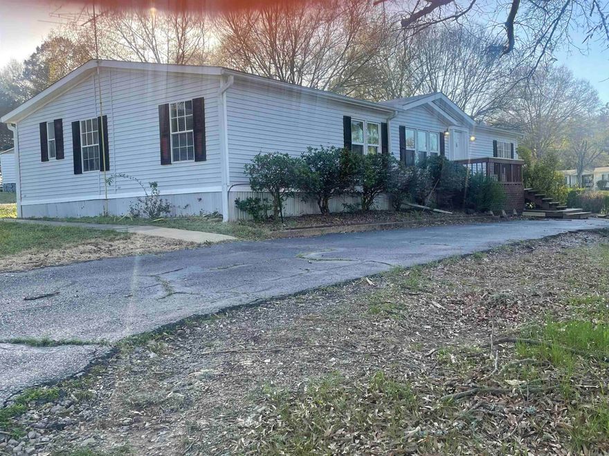 This 3bd/2ba is located in Lake Hamiton school district and has a beautiful view overlooking a large pond that only Hummingbird Estates residents have access to. It has front and back decks, enclosed back porch and an outside storage building.  Inside boasts and oversized laudry room, tons of kitchen counter space, storage, fireplace and built-ins. POA covers subdivision septic system and mowing and lighting of the common areas. New heat and air, new roof, new vinyl flooring in bedrooms (no longer carpet as pictures show). Previously rented at $1200/month.Non permanent foundation.