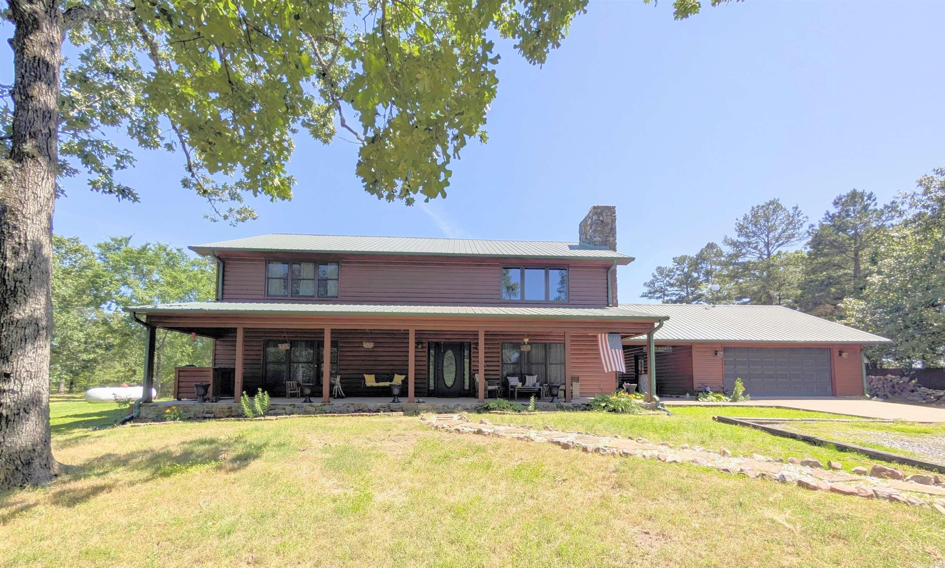 This house has what everyone wants - just outside the city limits, log 2-story home with open living spaces and mountain views. Large shop with 220 service w/elec & plumbing run to the shop. Home features tilt-out windows, WBFP w/blowers, kitchen has Corian counter tops and new appliances. In ground heated pool w/new pump and new liner, hot tub, large patio, covered deck, second story deck/balcony overlooking the pool, breezeway with over sized swing, EF5 rated storm shelter, extra landscaping, garden spot, wooded in front and back, with an abundance of wildlife and deer. Industrial shelving in garage, whole home generator. Must see!