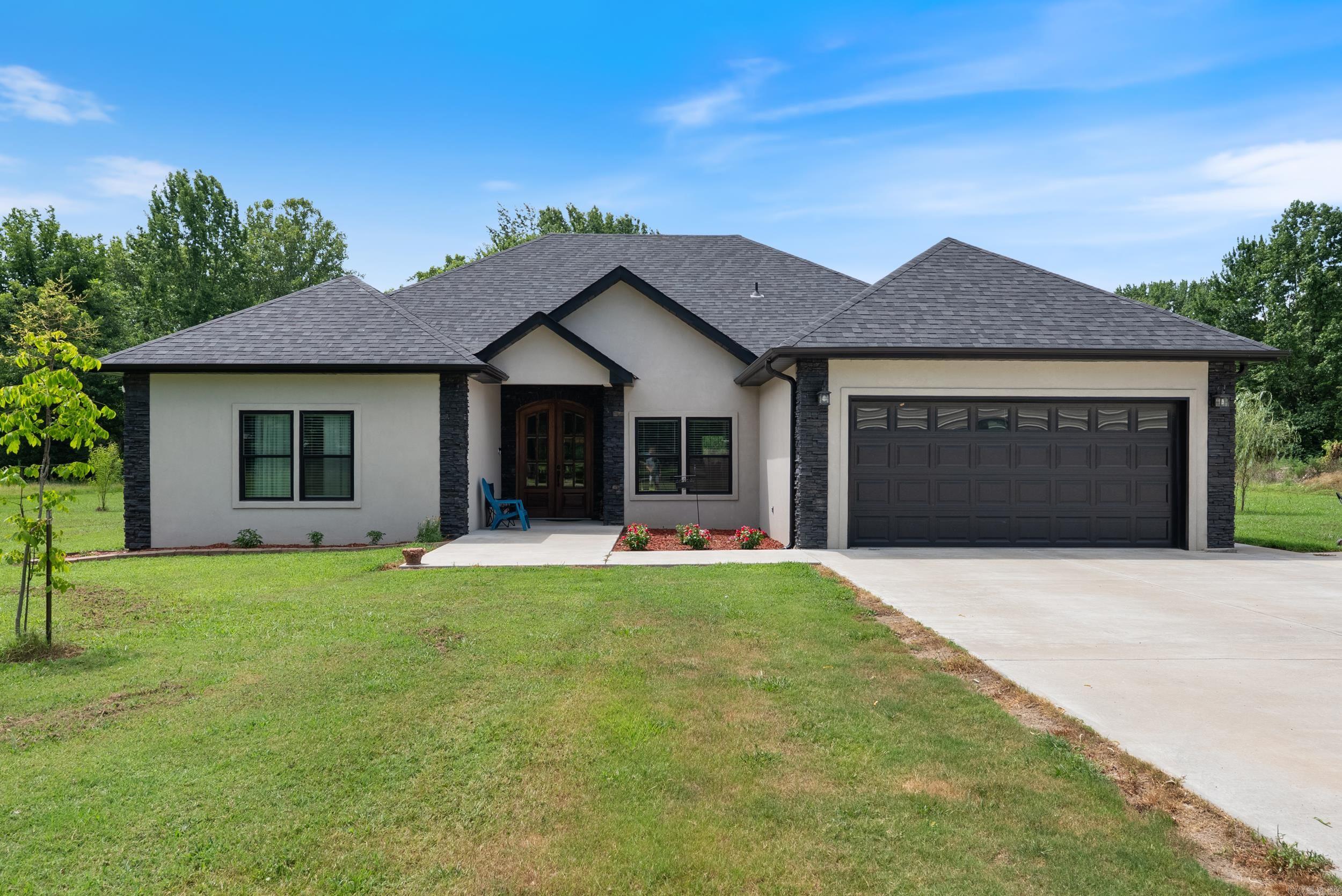Beautiful home sitting on one acre. 4 spacious bedrooms, 2 private bathrooms and one half bathroom for the guests. Open concept to allow for family/friend gatherings. Comes with one storage building and carport. Tile walk in showers in both bathrooms and tile flooring throughout the house. Spacious walk in closet in primary suite. Granite countertops with a massive island for extra sitting space. Backyard has a 3 season sitting area along with a newly built covered deck.