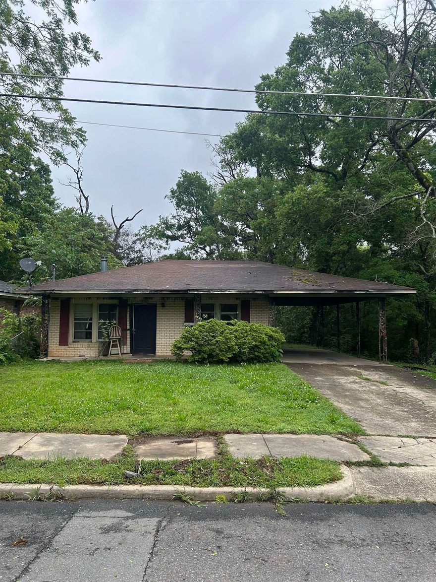 Welcome to this 3-bedroom, 1.5-bath brick home offering 1,261 square feet, a carport, and just enough fire damage to make things interesting. This half-baked beauty has been tastefully pre-distressed, saving you years of wear and tear. Thankfully, the exterior remains intact, as well as portions of the interior.  Inside, you’ll find a functional floor plan, solid bones, and renovation potential throughout. Select areas feature an “open ceiling concept,” while some rustic charred accents add a level of character you simply can’t recreate with modern design trends.  With damage limited to only part of the home, this property offers a rare chance to restore, rebuild, and build equity all at once. Whether you’re an investor, flipper, or ambitious homeowner, this could be your opportunity to own the house everyone on the block will remember.  Being sold AS-IS.