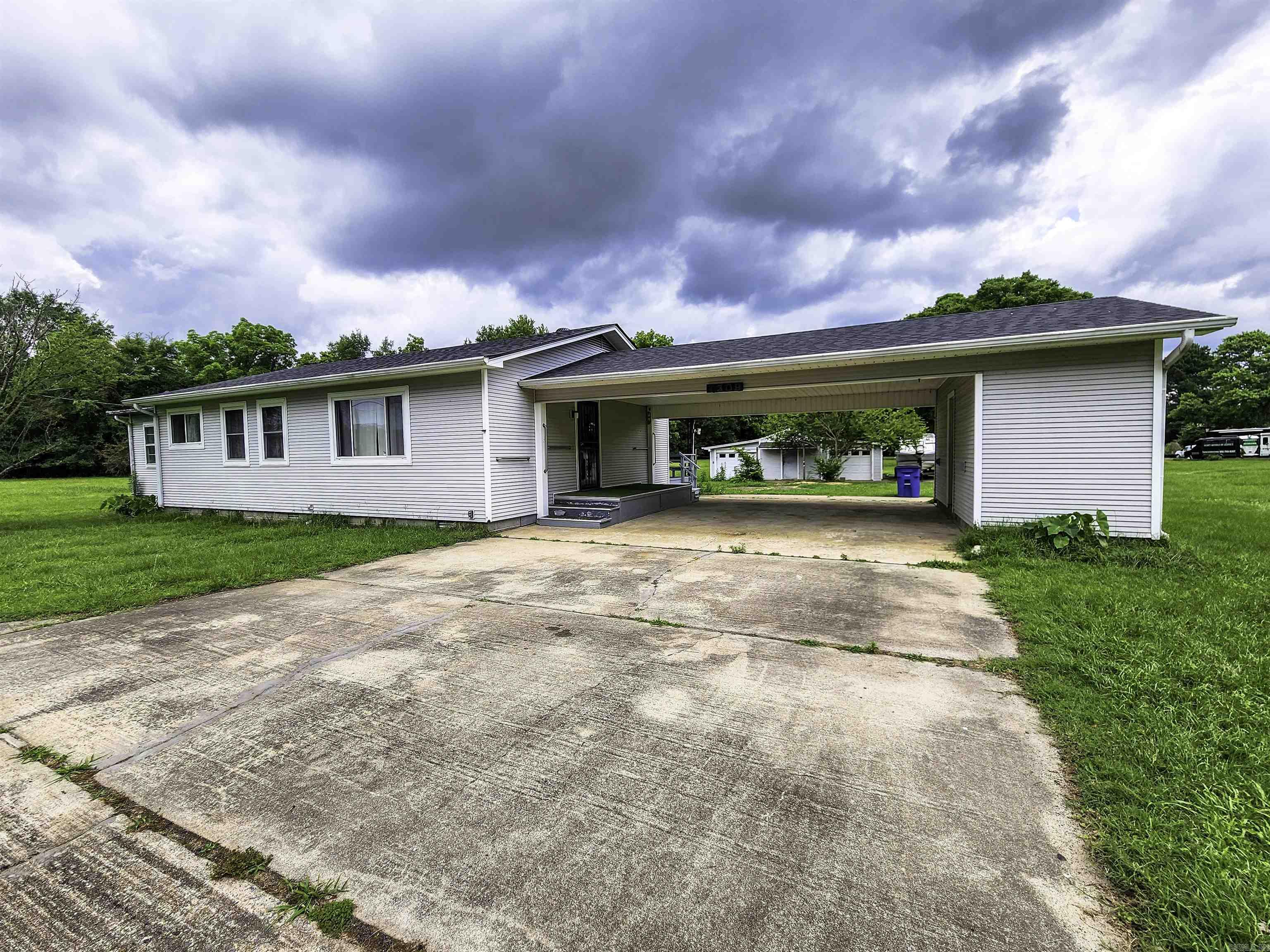 Welcome to your own slice of country charm on approximately 2.67 acres in North Little Rock! This inviting home features a brand-new roof and stylish new flooring throughout. Enjoy relaxing on the 12x16 covered back porch, perfect for morning coffee or evening sunsets. Inside, the oversized laundry room adds everyday convenience, hot water heater installed in 2023, while two large shop buildings out back offer incredible flexibility for a workshop, storage, or creative studio. With land, updates, and endless possibilities, this affordable mini-homestead won’t last long!