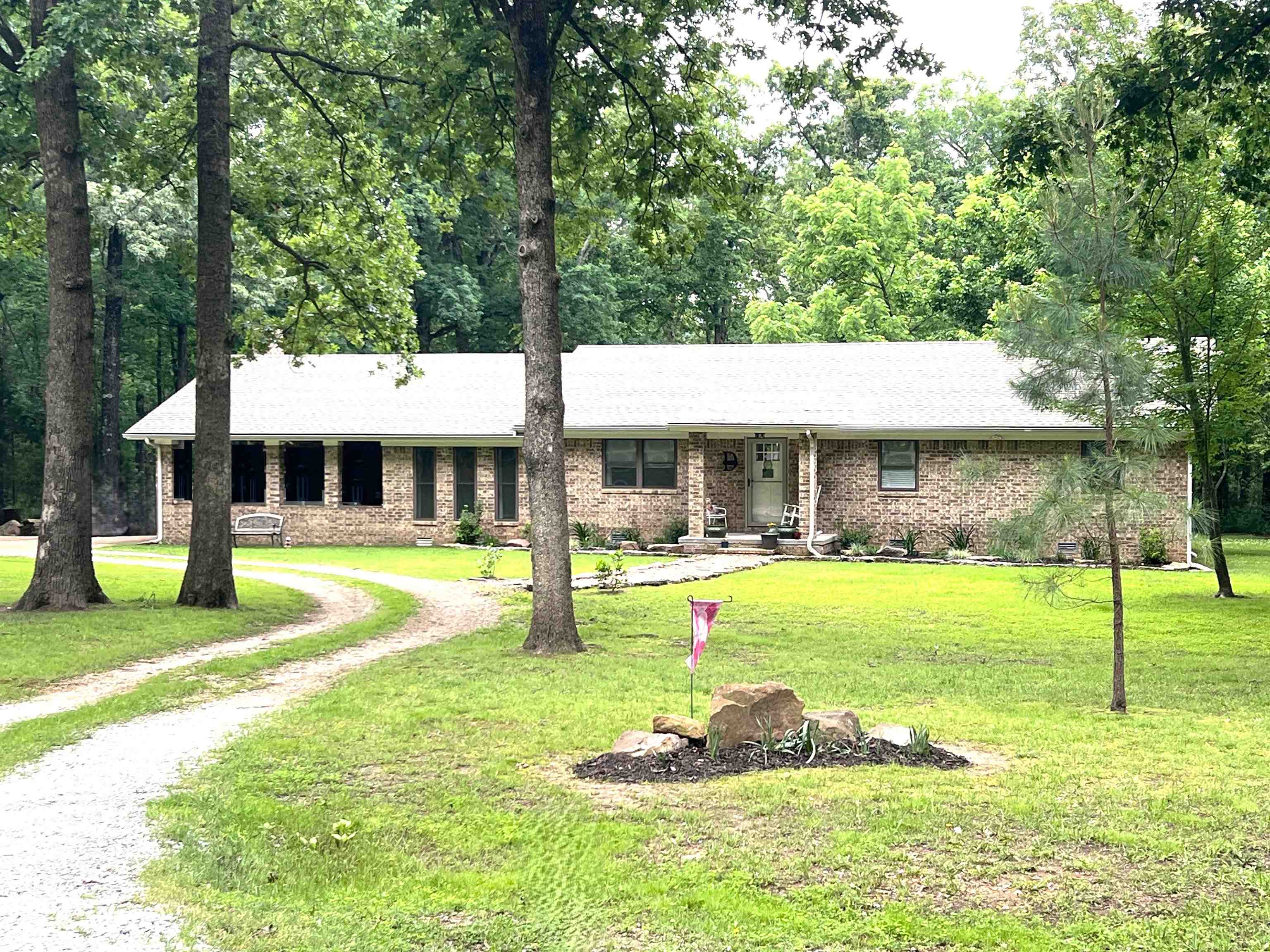 Enjoy peaceful country living with modern comfort in this beautifully maintained 3BR/2BA brick home on a level, park-like 1-acre lot—nestled on a quiet dead-end street just minutes from Mountain View’s music, shops, hospital, and schools. Offering 2,080 sqft, the home features crown molding in bedrooms and baths, a spacious living room, and an open kitchen/dining combo with granite counters, stainless appliances, gas range, and room for a large center island. A versatile flex room is perfect for a home office, studio, or second living space. Oversized laundry room provides added storage and utility. Laminate and carpet flooring throughout for easy care and comfort. Step outside to a peaceful backyard ideal for relaxing, gardening, or raising chickens—no HOA! The 4-sides brick exterior ensures low maintenance, and the covered carport adds everyday convenience. A concrete pad currently serves as a basketball court but could easily accommodate a workshop or storage building. The horseshoe driveway adds generous parking for guests, trailers, or outdoor toys. Come see this perfect blend of charm, privacy, and rural beauty—ready for your Ozark lifestyle. (Interior pictures to follow)