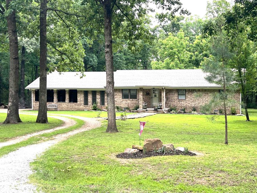 Enjoy peaceful country living with modern comfort in this beautifully maintained 3BR/2BA brick home on a level, park-like 1-acre lot—nestled on a quiet dead-end street just minutes from Mountain View’s music, shops, hospital, and schools. Offering 2,080 sqft, the home features crown molding in bedrooms and baths, a spacious living room, and an open kitchen/dining combo with granite counters, stainless appliances, gas range, and room for a large center island. A versatile flex room is perfect for a home office, studio, or second living space. Oversized laundry room provides added storage and utility. Laminate and carpet flooring throughout for easy care and comfort. Step outside to a peaceful backyard ideal for relaxing, gardening, or raising chickens—no HOA! The 4-sides brick exterior ensures low maintenance, and the covered carport adds everyday convenience. A concrete pad currently serves as a basketball court but could easily accommodate a workshop or storage building. The horseshoe driveway adds generous parking for guests, trailers, or outdoor toys. Come see this perfect blend of charm, privacy, and rural beauty—ready for your Ozark lifestyle. (Interior pictures to follow)