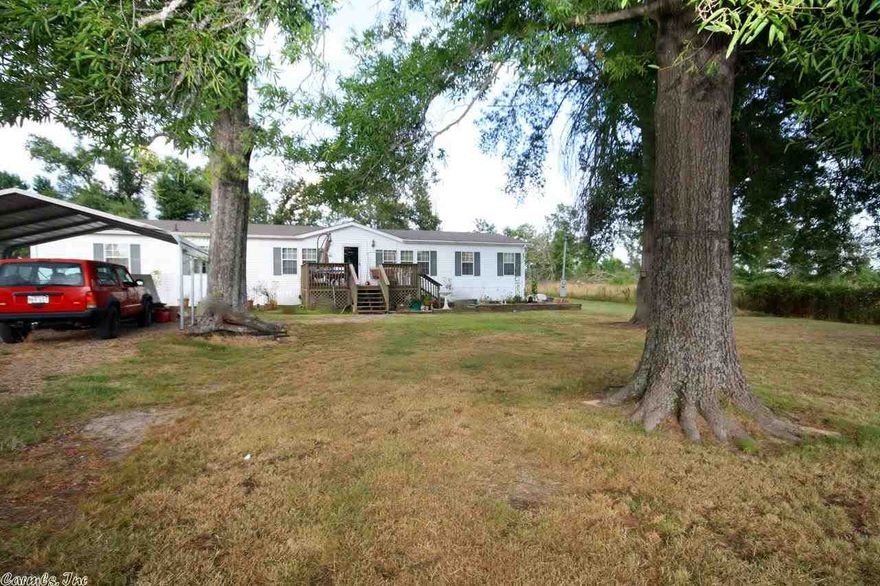 Price is for front mobile home and 6 acres, this mobile on a permanent foundation. Has lg kitchen w island, lg pantry, sep show & marble tub in master. Paved road with frontage on two sides!  Buyer could also purchase additional mobile on 6 acres in the back.  Has 20x20 shop/storage bldg.  Lots for the money here, must see to appreciate! See online amenity sheet for list of extras and see agent remarks.
