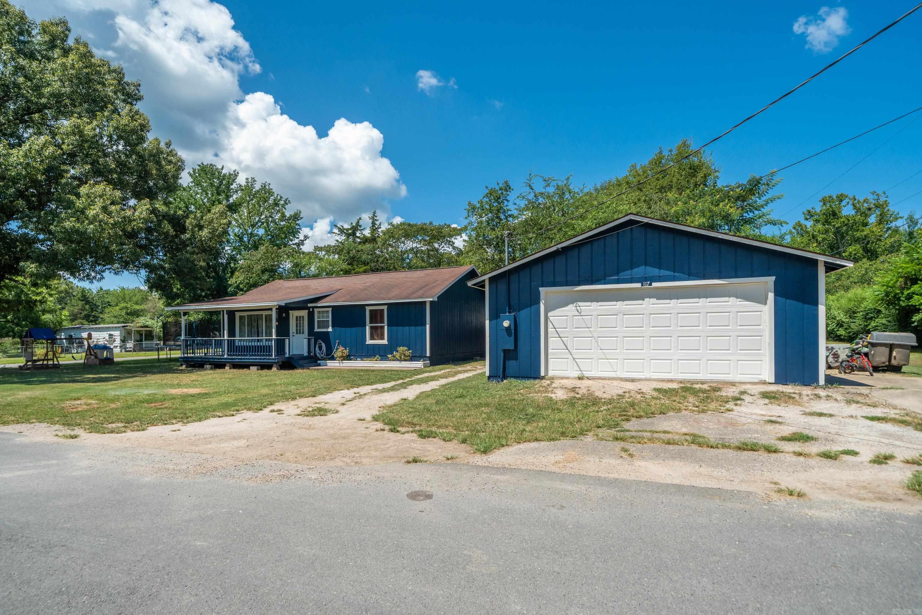 Welcome to this freshly painted 2-bedroom, 1-bath home nestled on a spacious corner lot in the heart of Mountain Pine, AR. Built in 2010 and thoughtfully updated, this all-electric gem offers the perfect blend of comfort and functionality. Step inside to find a bright and open floor plan with vaulted ceilings and laminate flooring throughout. The heart of the home is the oversized kitchen featuring custom natural wood cabinetry,as well as a large island bar, ideal for casual dining or entertaining. The living area is flooded with natural light from large windows and offers a warm, inviting space to gather. The home boasts several recent upgrades, including: HVAC (approx 2 years old), Roof (approx. 5 years old) ,Hot Water Heater (approx 3 years old), Electrical & Plumbing (both updated approx 3 years ago),Outside, enjoy a covered front porch perfect for relaxing, a flat grassy yard, and a detached 2-car garage/shop, ideal for hobbyists or additional storage. Located just minutes from Lake Ouachita and Hot Springs National Park.
