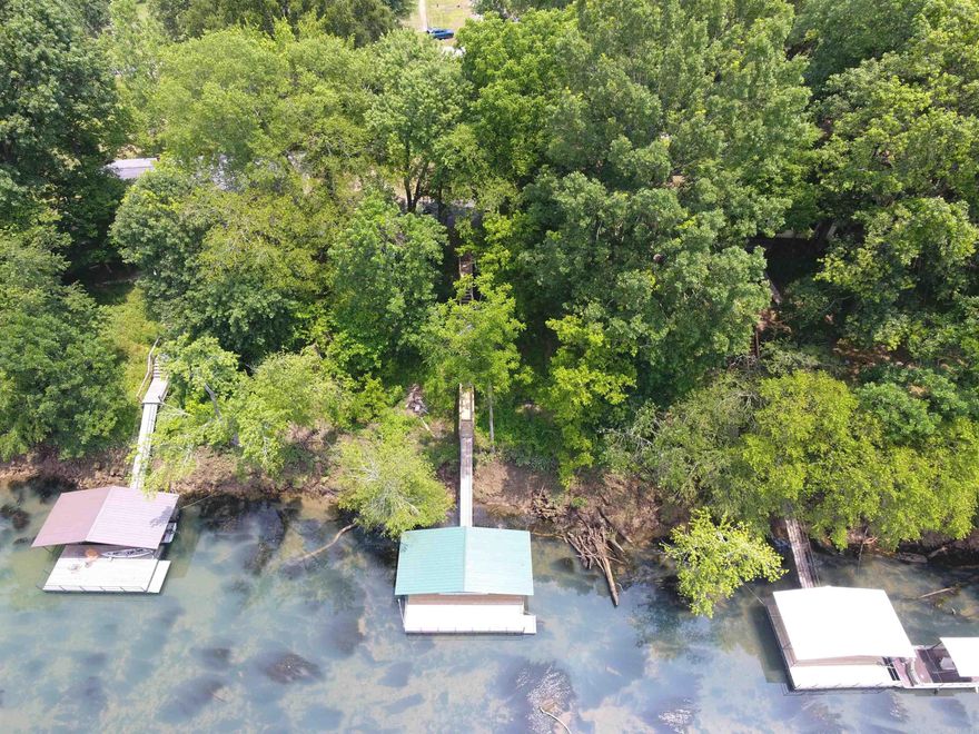 Beautiful level lot with ideal building site, cleared in front, mature shade trees in back. On a beautiful stretch of the Little Red, just below Richie Shoals. New boat dock and ramp, electric and water on the property.  Large, secure storage building/garage.  Not in flood zone, septic permit on file.  Minutes from shopping and services in Heber Springs, spectacular Greers Ferry Lake, golf at Riverland Country Club. City water and public utilities, riverfront living, easy and beautiful!