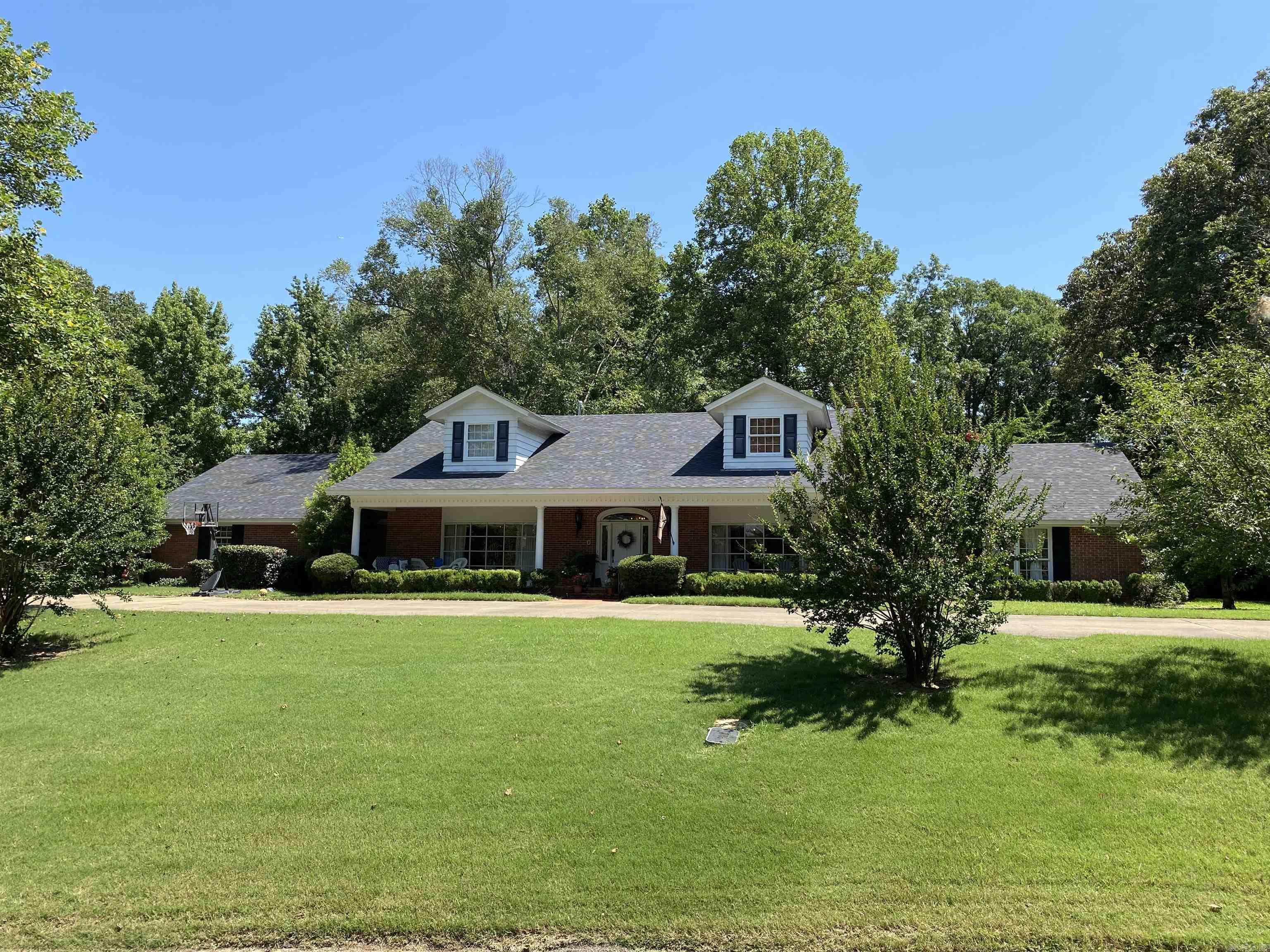This home was designed ahead of its time. You walk through the front door to beautiful marble floors and living room with a marble fire place gorgeous bay window on one side and a dinning room on the other. The vaulting ceiling with outstanding woodwork, crown molding, fireplace, bar is a must see family gathering room.This room leads out to the pretty brick patio for endless entertainment space. The kitchen has just been remodeled. Two bedrooms including the large master bedroom each have their own beautiful ensuite bathrooms. Upstairs has 2 more bedrooms/3bedrooms or bonus room with a full bath with double sinks. Extra features to the home a newer roof, HVAC and tankless water heater. Call listing agent to see this beauty!