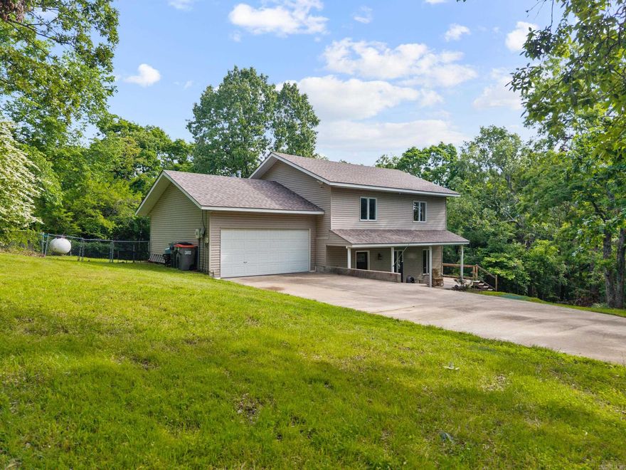 Welcome to your dream home near the lake! This beautifully designed property offers a spacious, open-concept layout that's perfect for both everyday living and entertaining. The seamless flow between the kitchen and living area creates a modern, airy atmosphere ideal for hosting family and friends.  Nestled on a generous lot just minutes from Hickory Creek Marina on Beaver Lake, this home invites you to unwind with breathtaking sunset views and lakeside serenity. Enjoy your afternoons playing frisbee golf in the yard or hosting gatherings on the expansive 12’ x 45’ deck — perfect for indoor/outdoor entertaining.    Upstairs, you'll find all bedrooms thoughtfully situated for privacy, along with a massive media room/man cave complete with a kitchenette — perfect for movie nights or a home gym setup. The primary suite features a private deck overlooking the yard, and the recently remodeled ensuite bathroom offers a touch of luxury.  Don’t miss your chance to make this incredible home yours! Schedule a showing today!