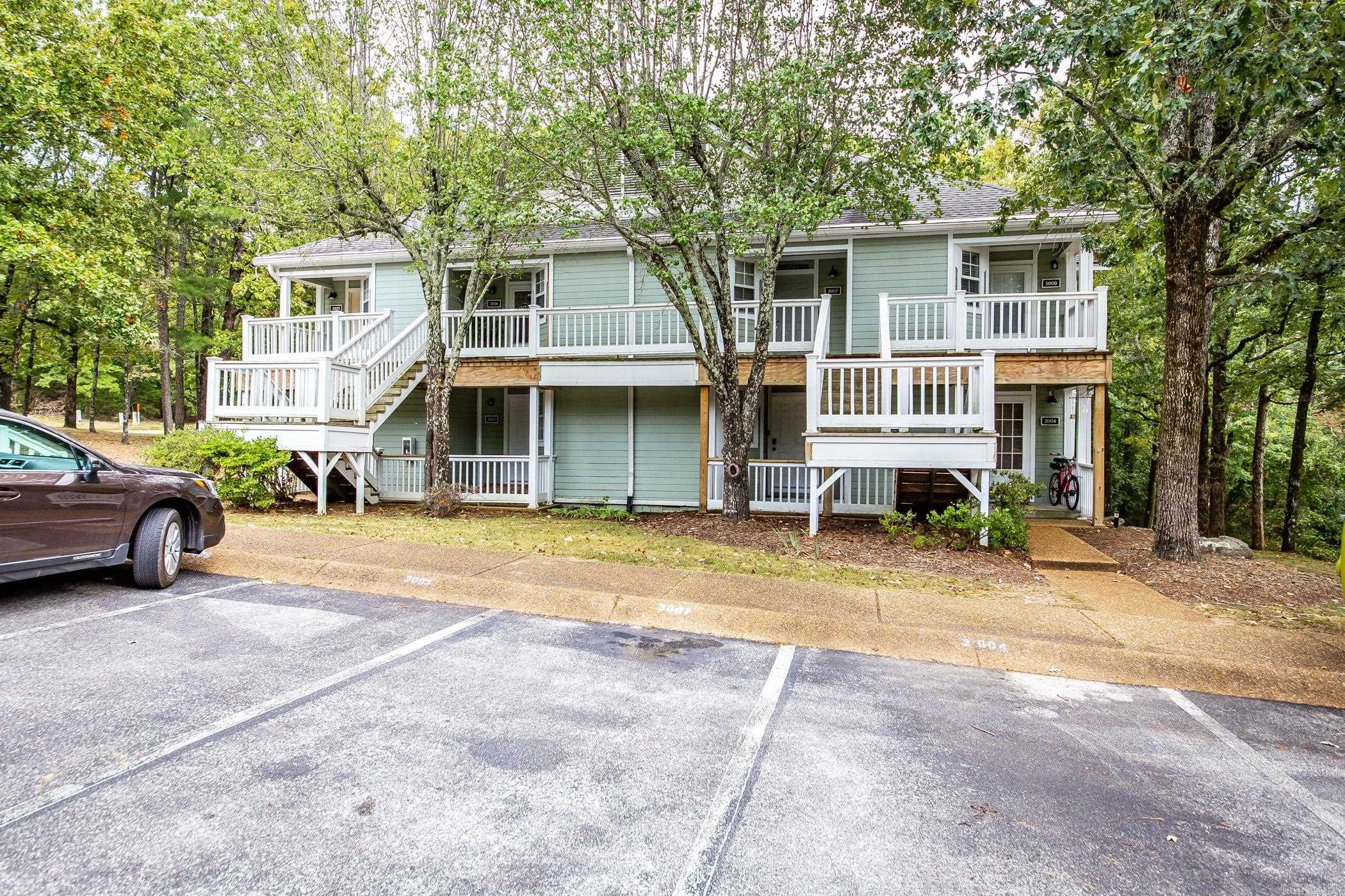 This stunning, updated studio is tucked away among the trees on the lower floor. It has been recently updated with new floors, a fresh coat of paint, and negotiable comfortable furnishings, making it ready for immediate occupancy. The $1,500 special assessment has been paid in full for stair replacement. The space is efficiently designed with a snug sleeping area, a bathroom with a shower, a kitchenette, and a full-size washer and dryer. Unwind on the back deck with a view of the woods or take advantage of the nearby resort amenities, including three pools, two golf course, minutes from pristine Greers Ferry Lake and all that Fairfield Bay, Arkansas has to offer. Ideal for use as a tranquil Ozark Mountain retreat, a permanent residence, or an income-generating property.