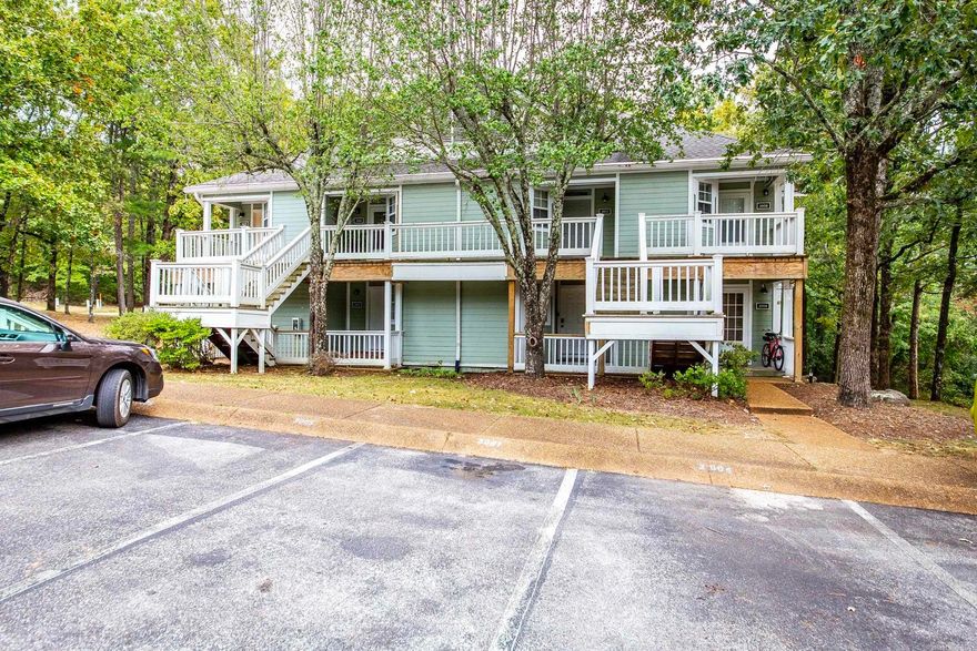 This stunning, updated studio is tucked away among the trees on the lower floor. It has been recently updated with new floors, a fresh coat of paint, and negotiable comfortable furnishings, making it ready for immediate occupancy. The $1,500 special assessment has been paid in full for stair replacement.  The space is efficiently designed with a snug sleeping area, a bathroom with a shower, a kitchenette, and a full-size washer and dryer. Unwind on the back deck with a view of the woods or take advantage of the nearby resort amenities, including three pools, two golf course, minutes from pristine Greers Ferry Lake and all that Fairfield Bay, Arkansas has to offer. Ideal for use as a tranquil Ozark Mountain retreat, a permanent residence, or an income-generating property.